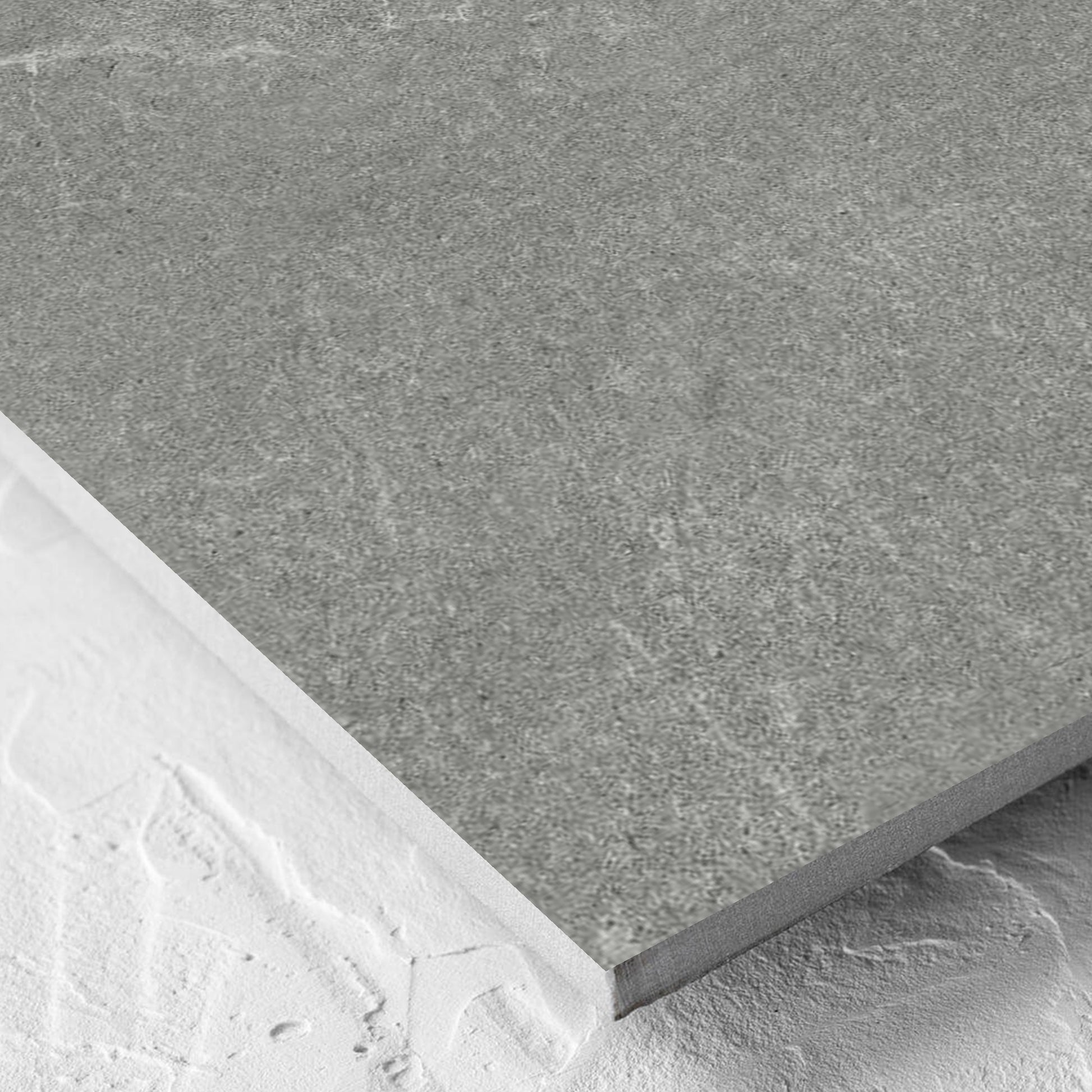 Corner close-up of the Lava Grey Amber 600x600mm tile showing the grey lappato surface and the edge profile