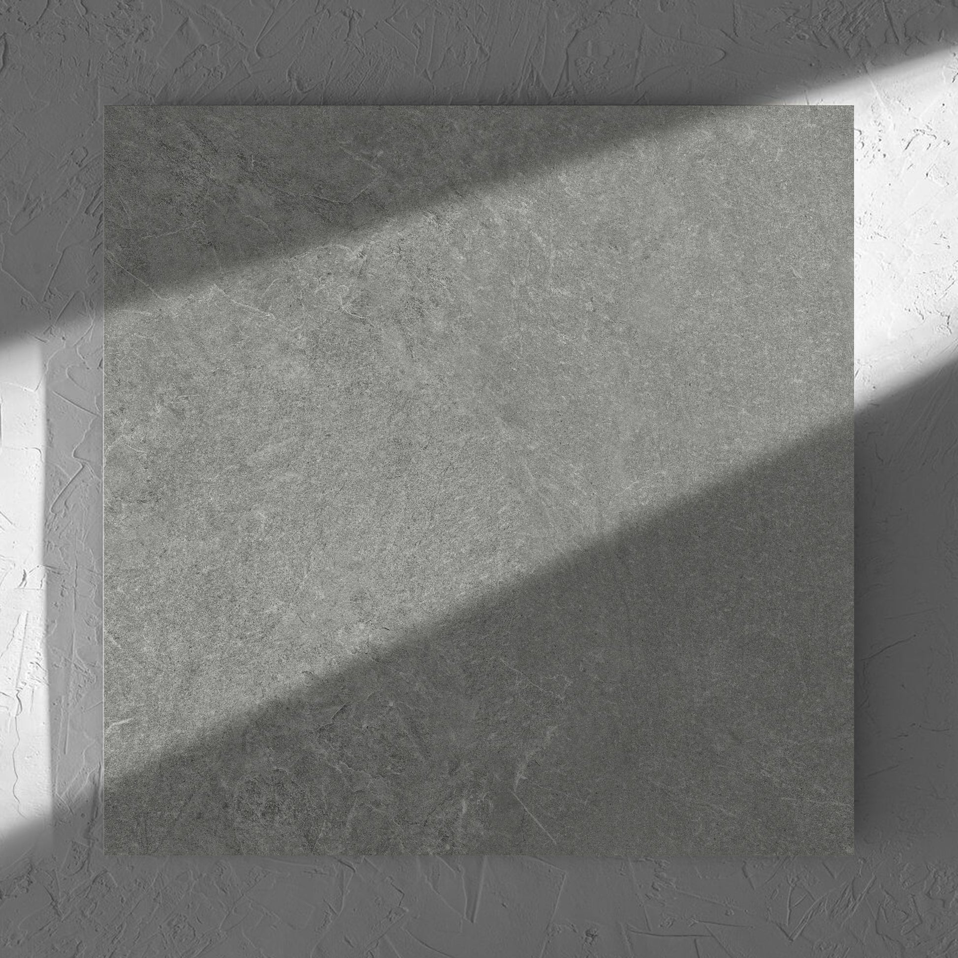 Lava Grey Amber 600x600mm tile in soft natural window light, showing the grey lappato surface