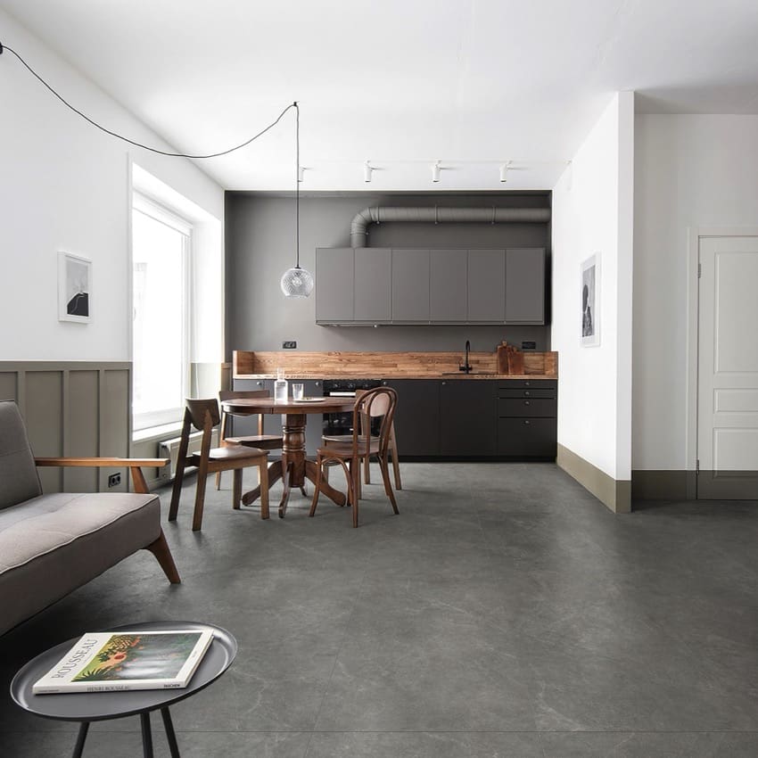 Lava Grey Amber Brick/Subway 75x300mm tiles laid as an open-plan kitchen and dining floor, complementing dark cabinetry, timber splashback, and a pendant light.