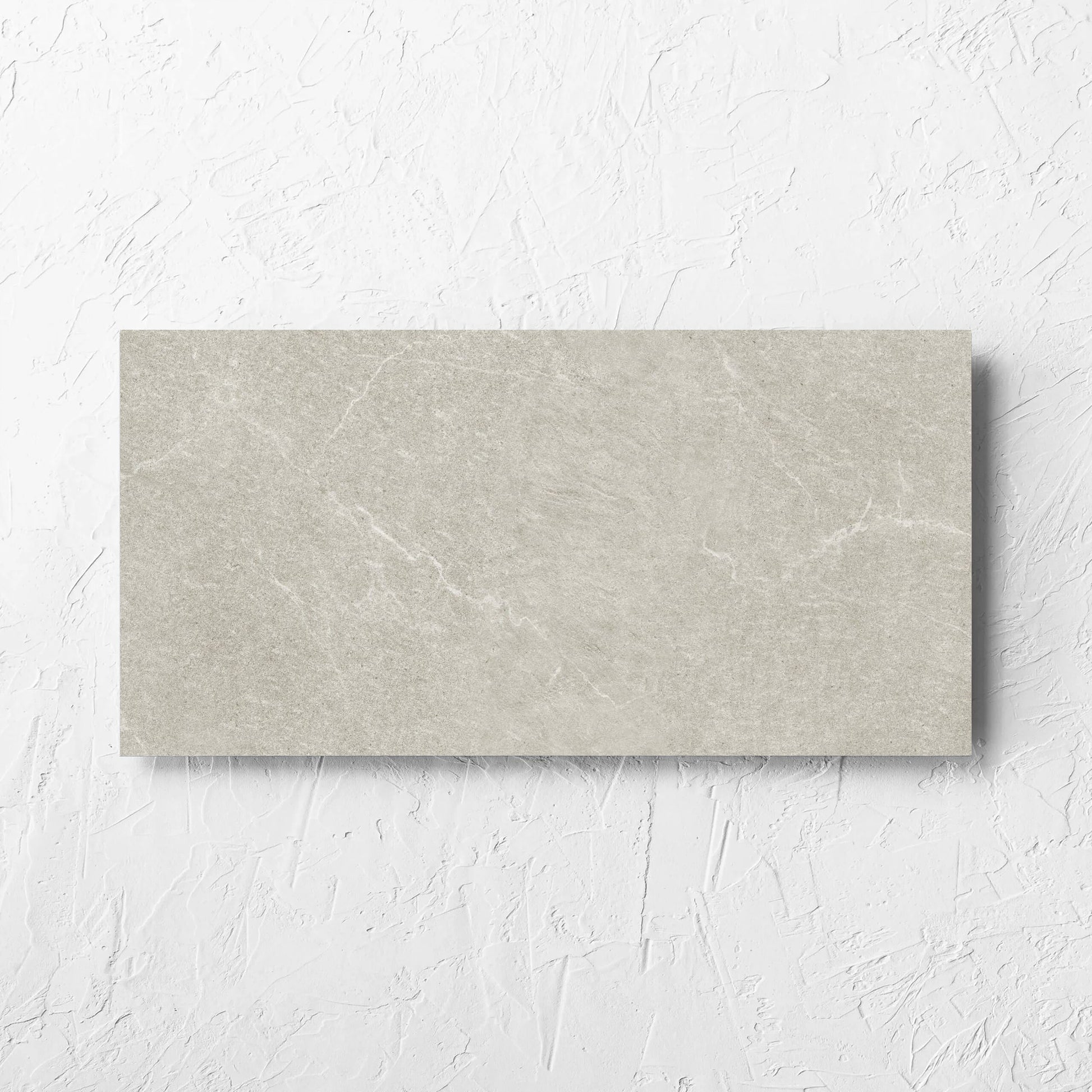 Lava Soft Beige Amber 300x600mm tile laid flat on a white rendered wall, showing the soft beige lappato surface