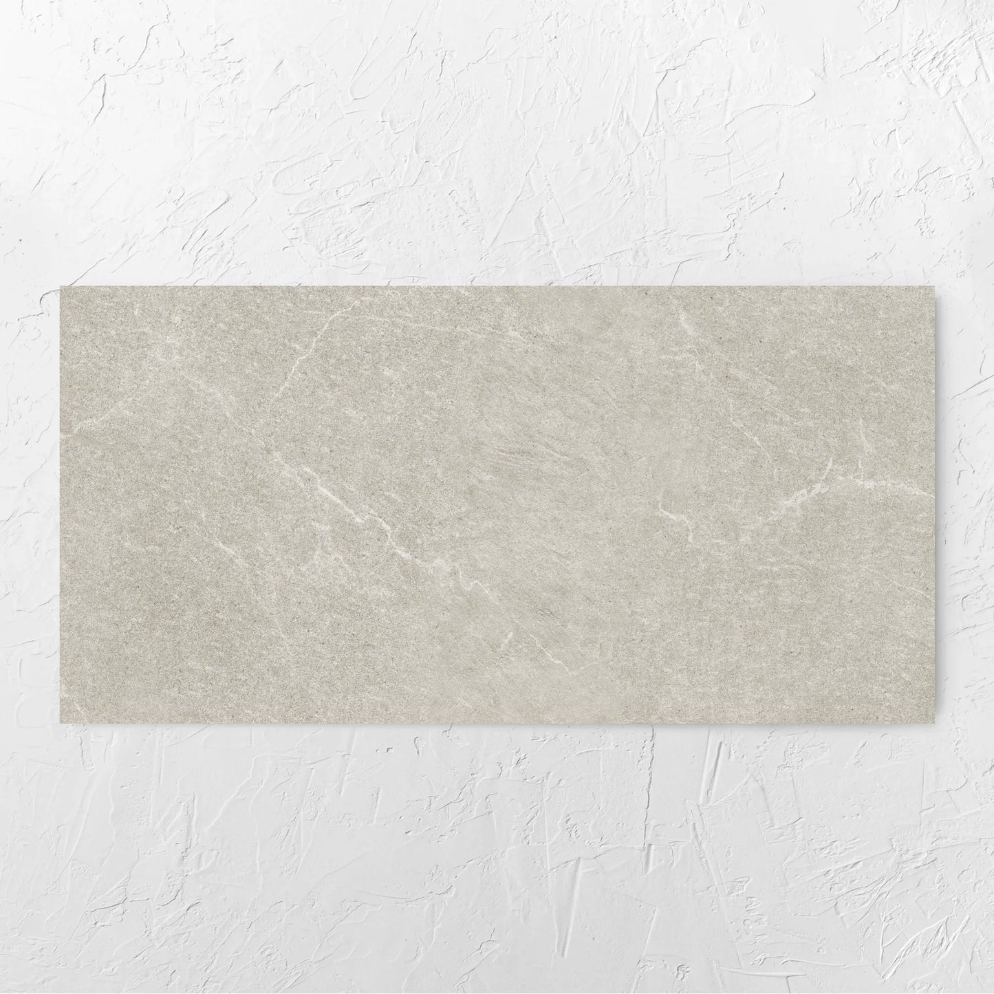 Lava Soft Beige Amber 600x1200mm tile laid flat on a white rendered wall, showing the tile surface