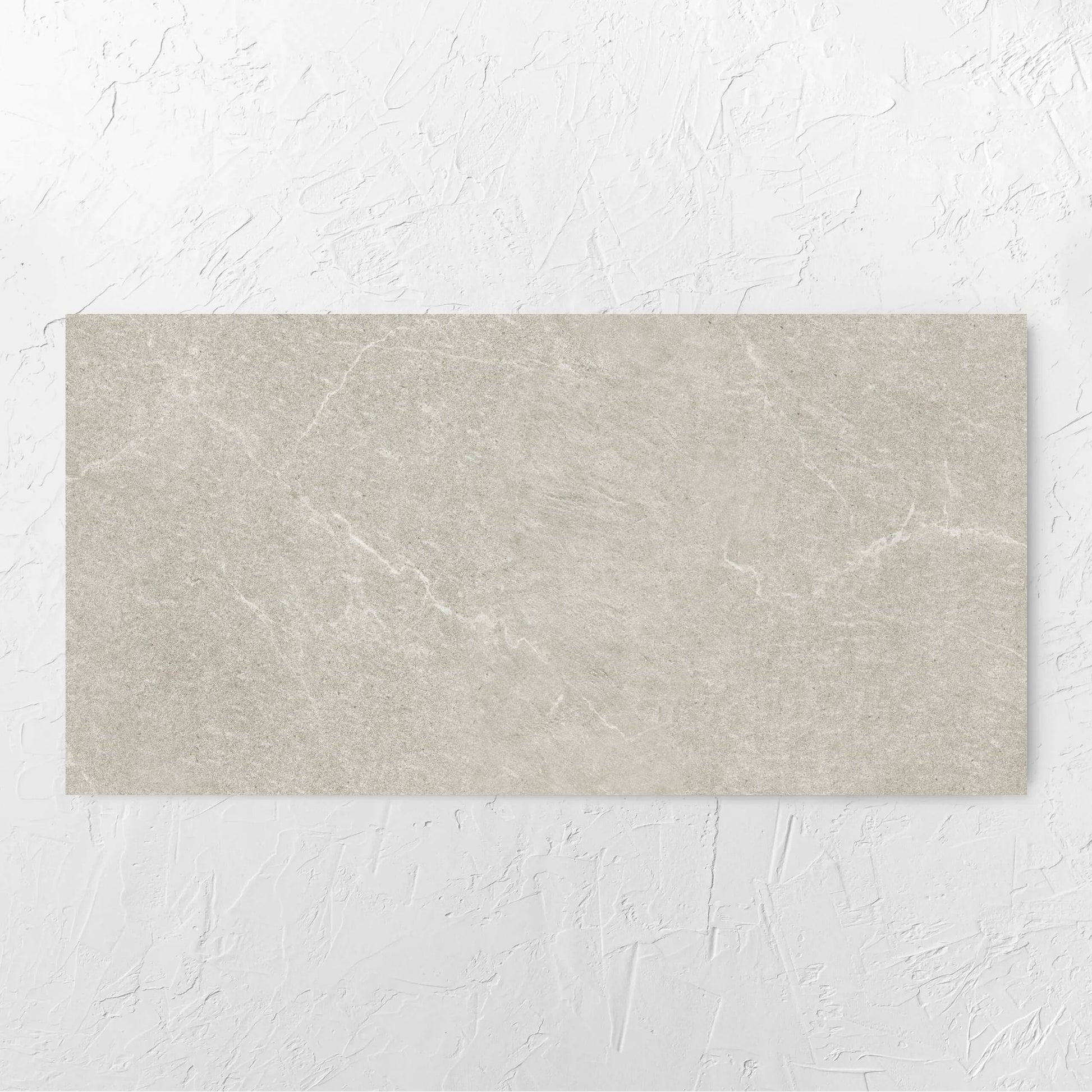 Lava Soft Beige Amber 600x1200mm tile laid flat on a white rendered wall, showing the tile surface