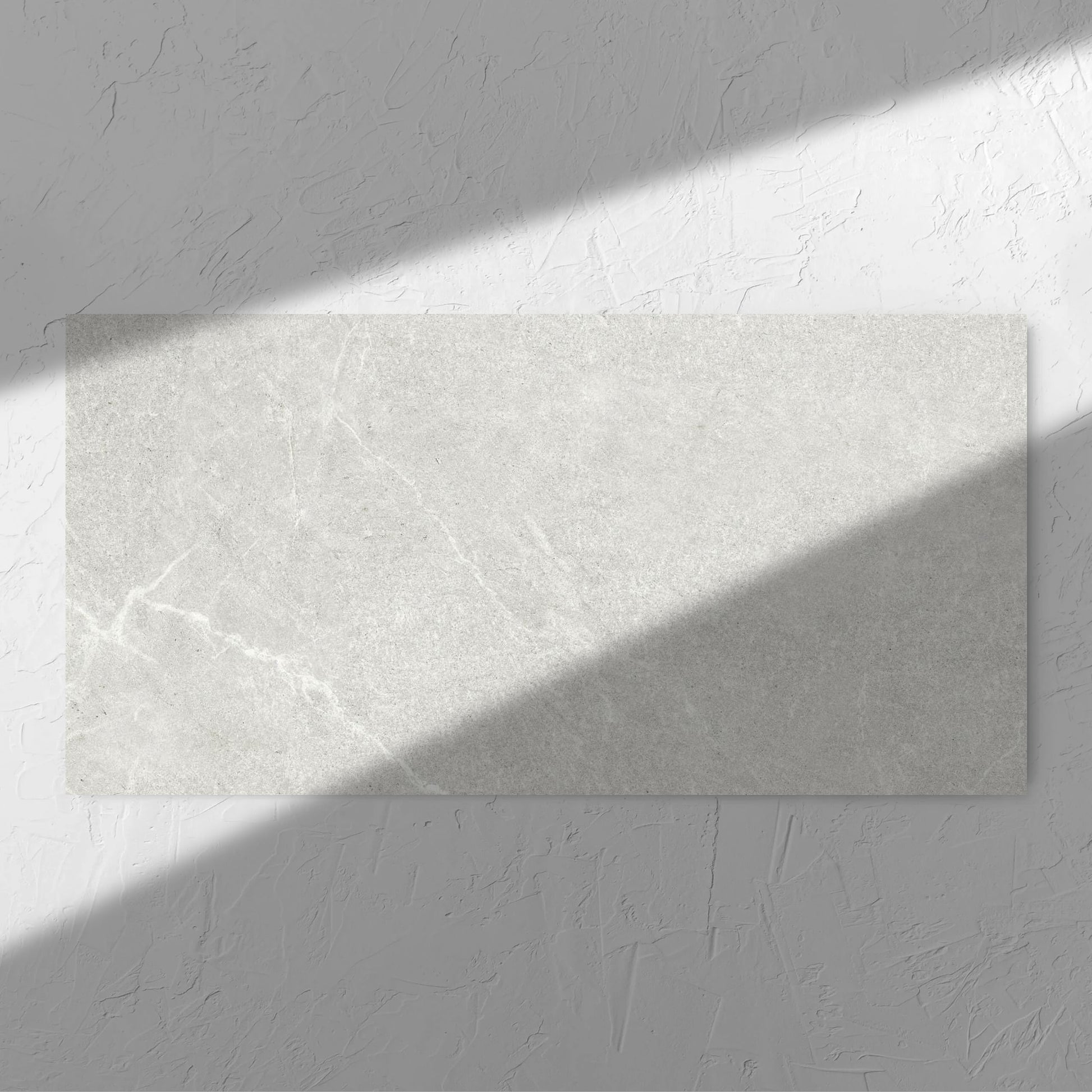 Lava Warm Grey Amber 600x1200mm tile in soft natural window light, showing the warm grey surface