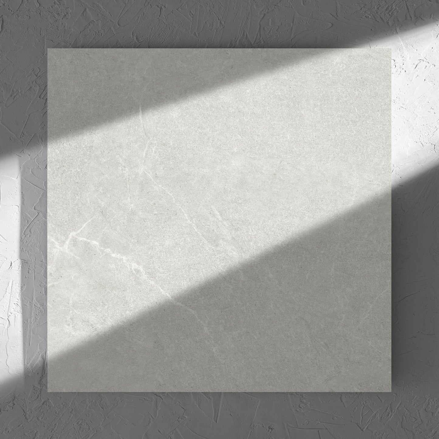 Lava Warm Grey Amber 600x600mm tile in soft natural window light, showing the tile surface