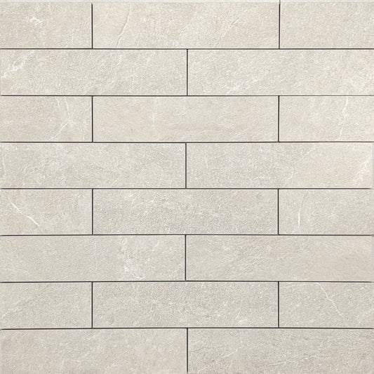 Flat lay of Lava Warm Grey Amber Brick/Subway 75x300mm tiles showing a staggered brick pattern with a matte stone finish in soft warm grey tones.
