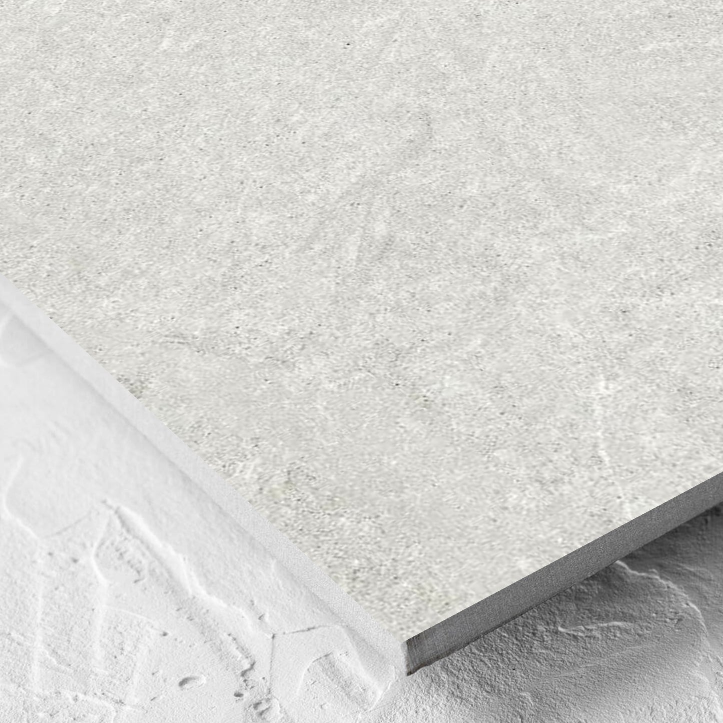 Corner close-up of the Lava Warm Grey Inout 600x600mm tile showing the tile surface and the edge profile
