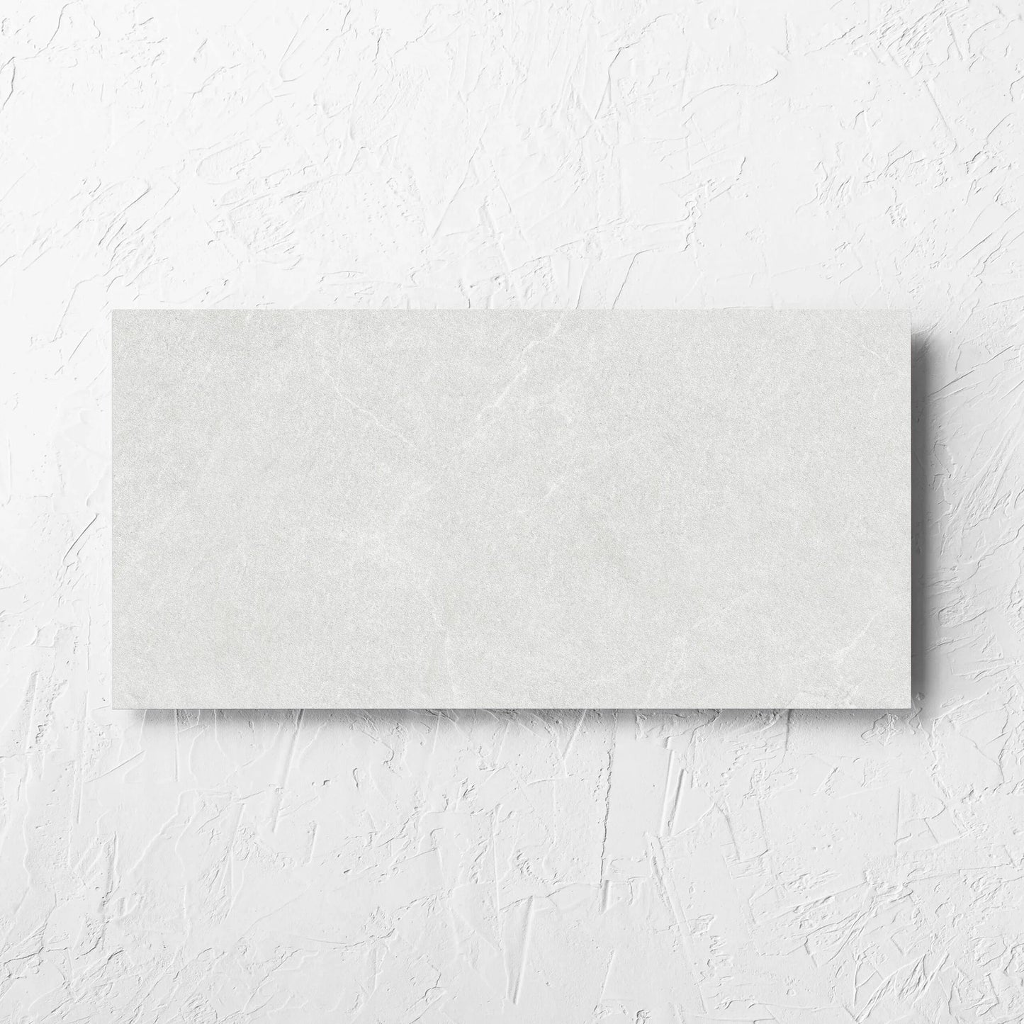 Lava White Amber 300x600mm tile laid flat on a white rendered wall, showing the tile surface