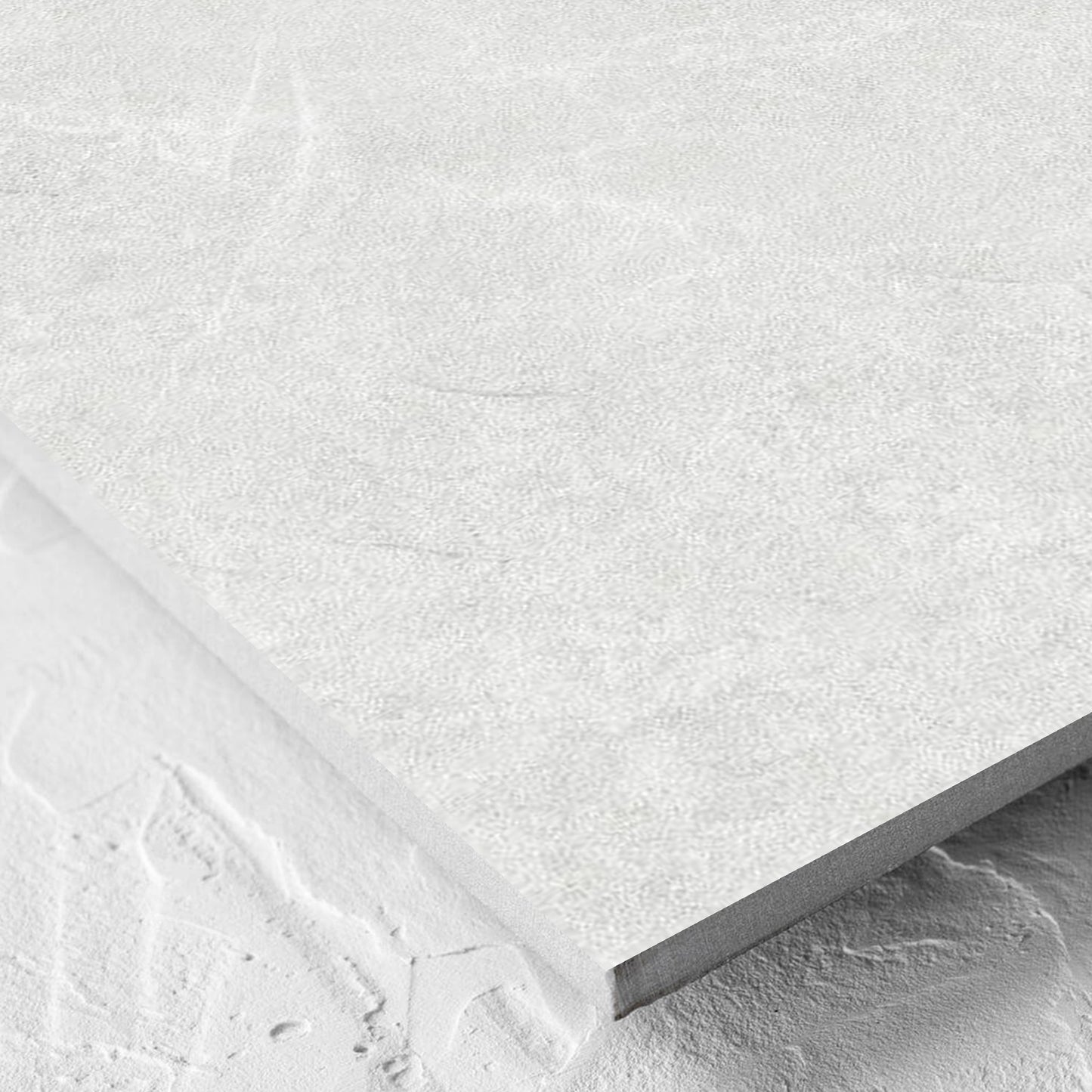 Corner close-up of the Lava White Inout 600x600mm tile showing the white lappato surface and the edge profile