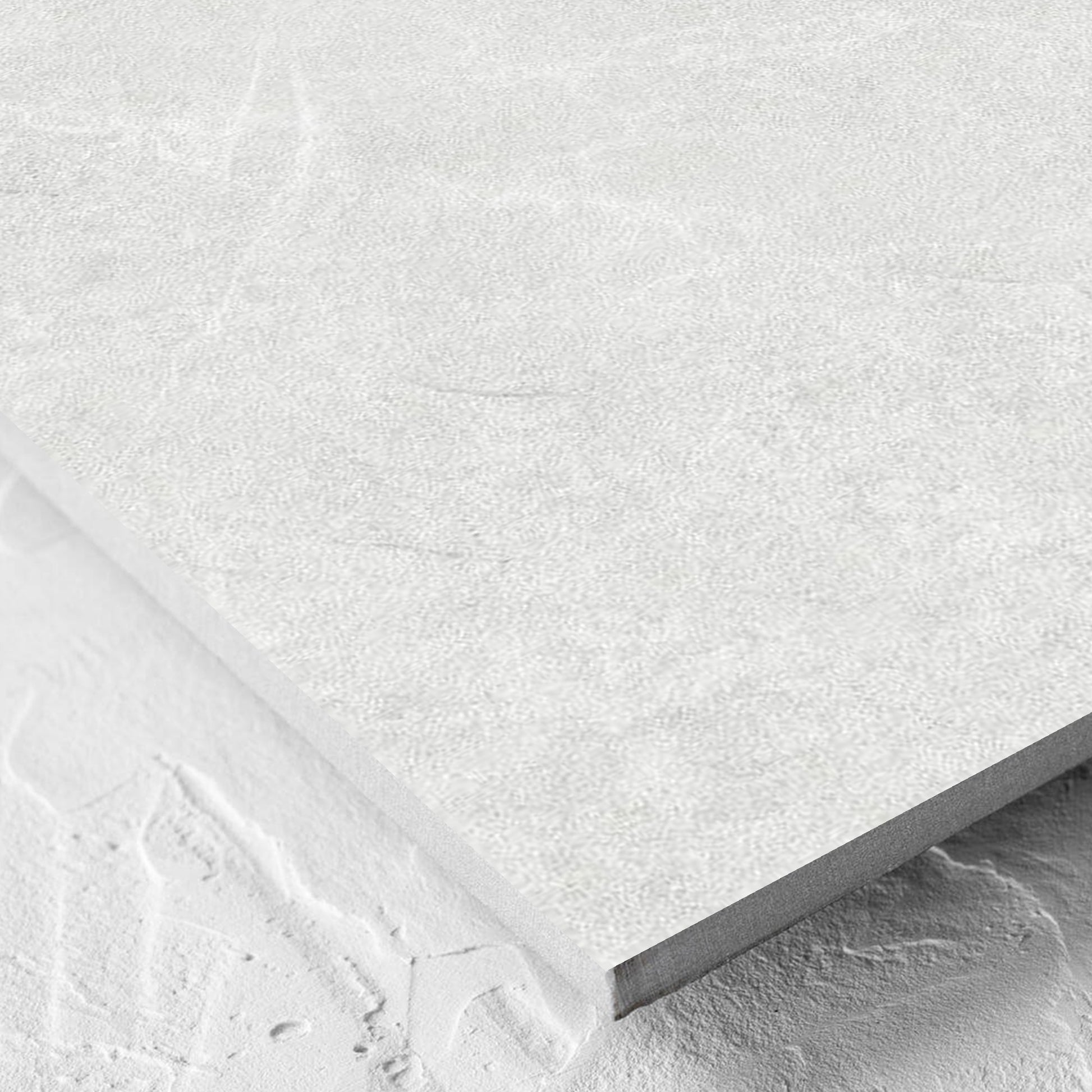 Corner close-up of the Lava White Inout 600x600mm tile showing the white lappato surface and the edge profile