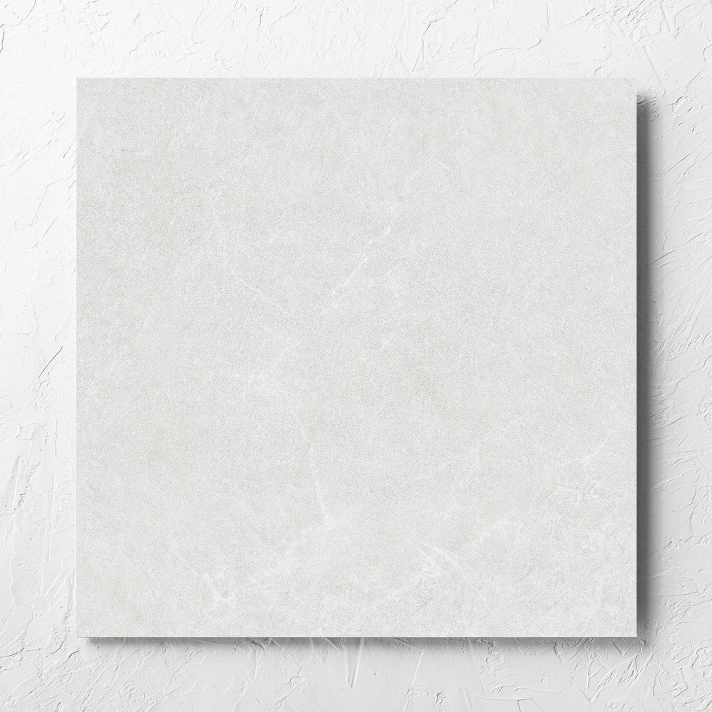 Lava White Inout 600x600mm tile laid flat on a white rendered wall, showing the white lappato surface