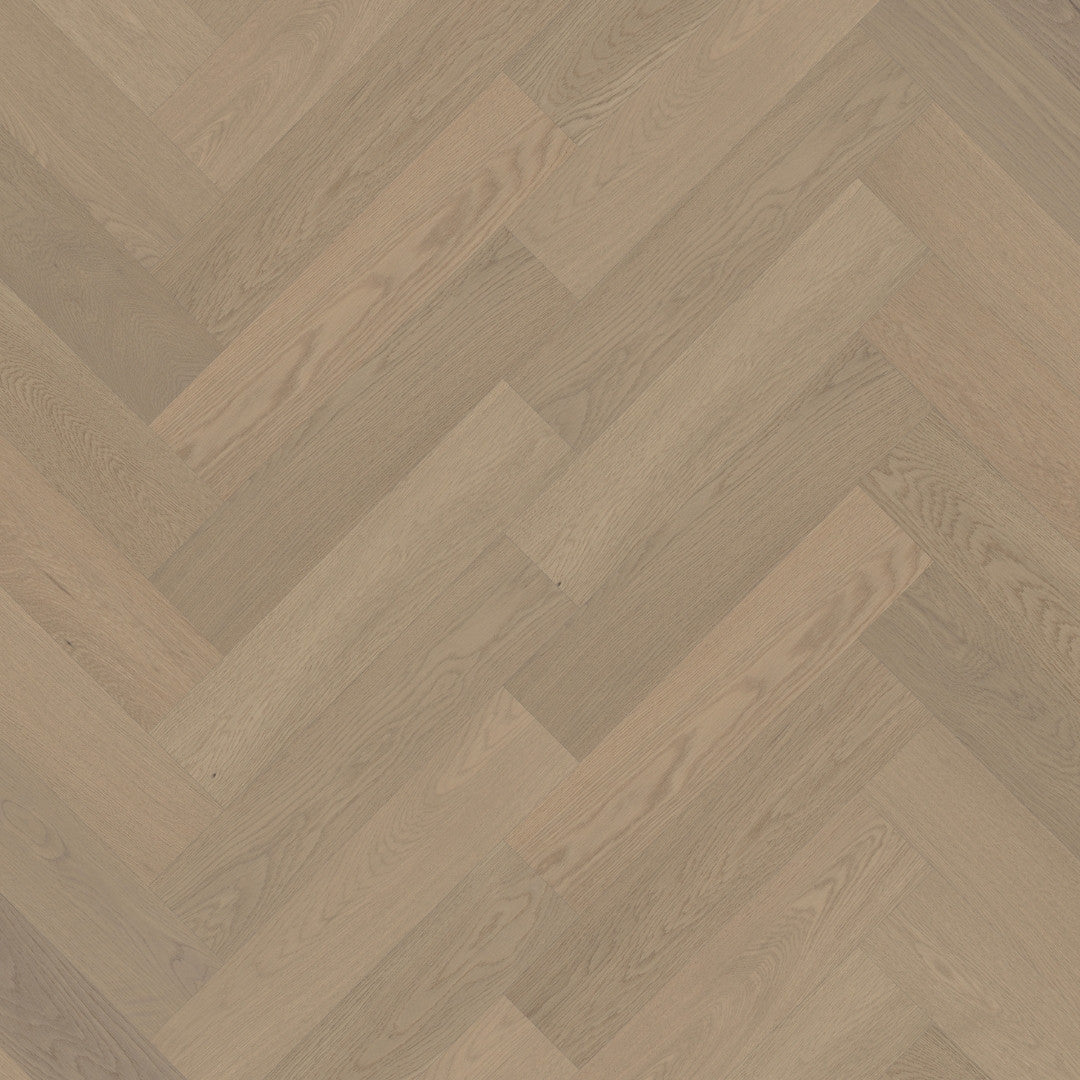 Close-up of Light Neutral iDesign Herringbone Flooring 15/3mm showing a diagonal herringbone pattern with warm greige oak wood grain texture.