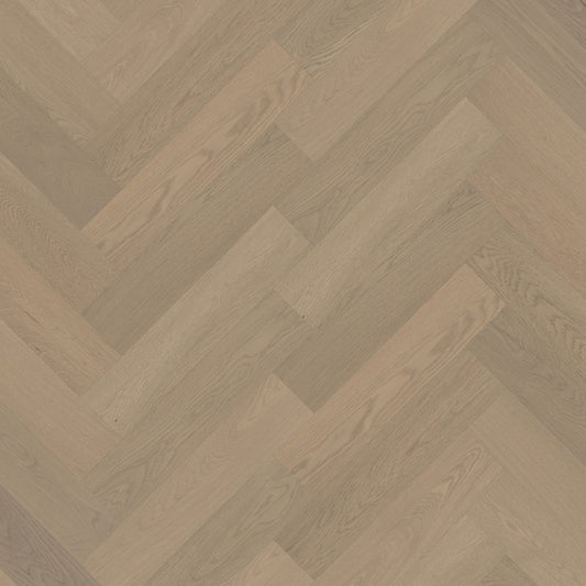 Close-up of Light Neutral iDesign Herringbone Flooring 15/3mm showing a diagonal herringbone pattern with warm greige oak wood grain texture.