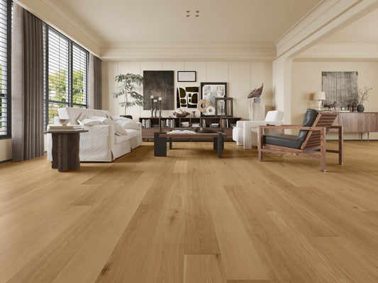 Light Tan Classique Oak Flooring 14/2mm installed in a spacious modern living room with white sofas, dark wood furniture, and large windows.