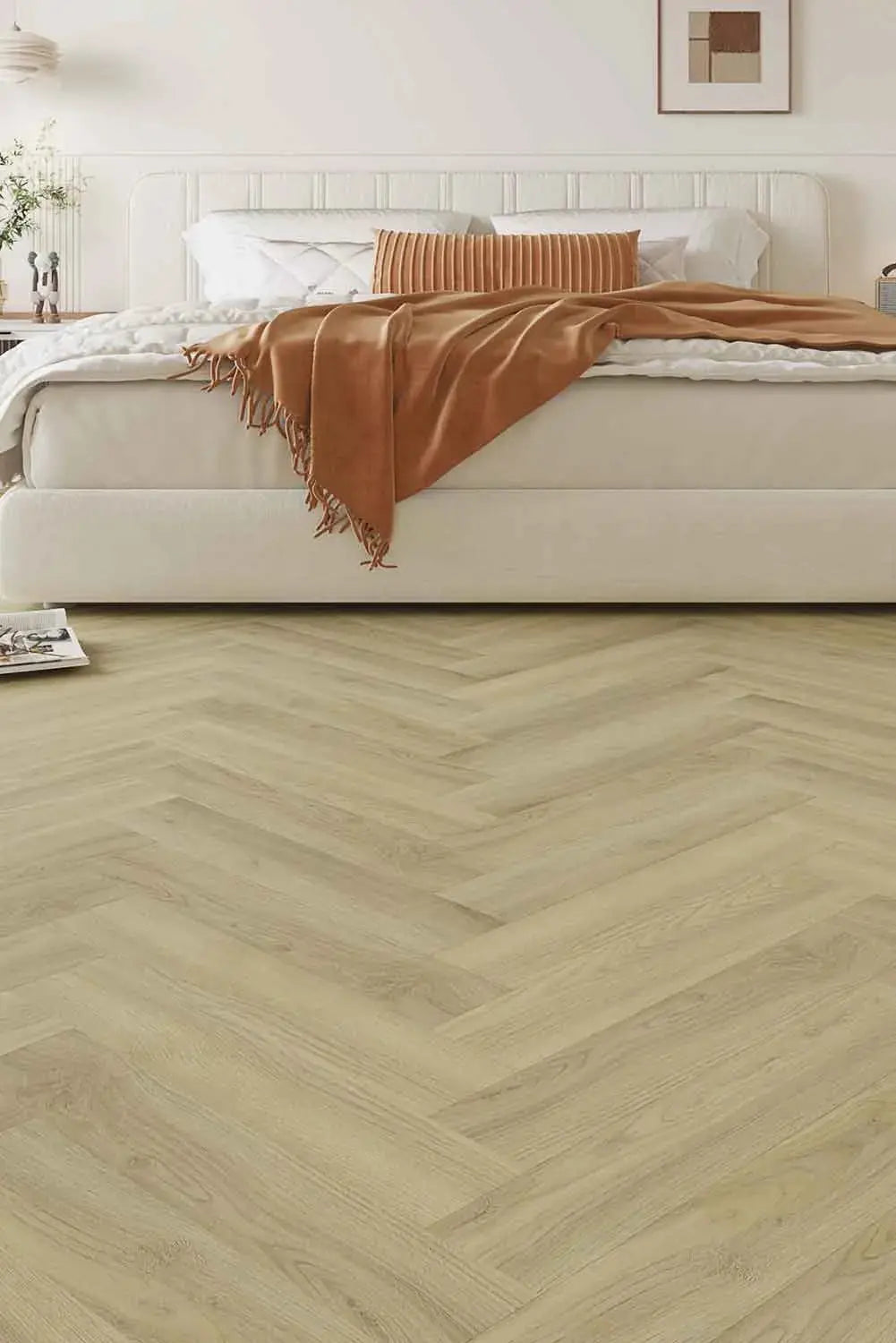 Lime Ash Elegant SPC Hybrid 9.5mm Flooring 7.5+2mm installed in a herringbone pattern in a bright modern bedroom with a white upholstered bed and terracotta throw.