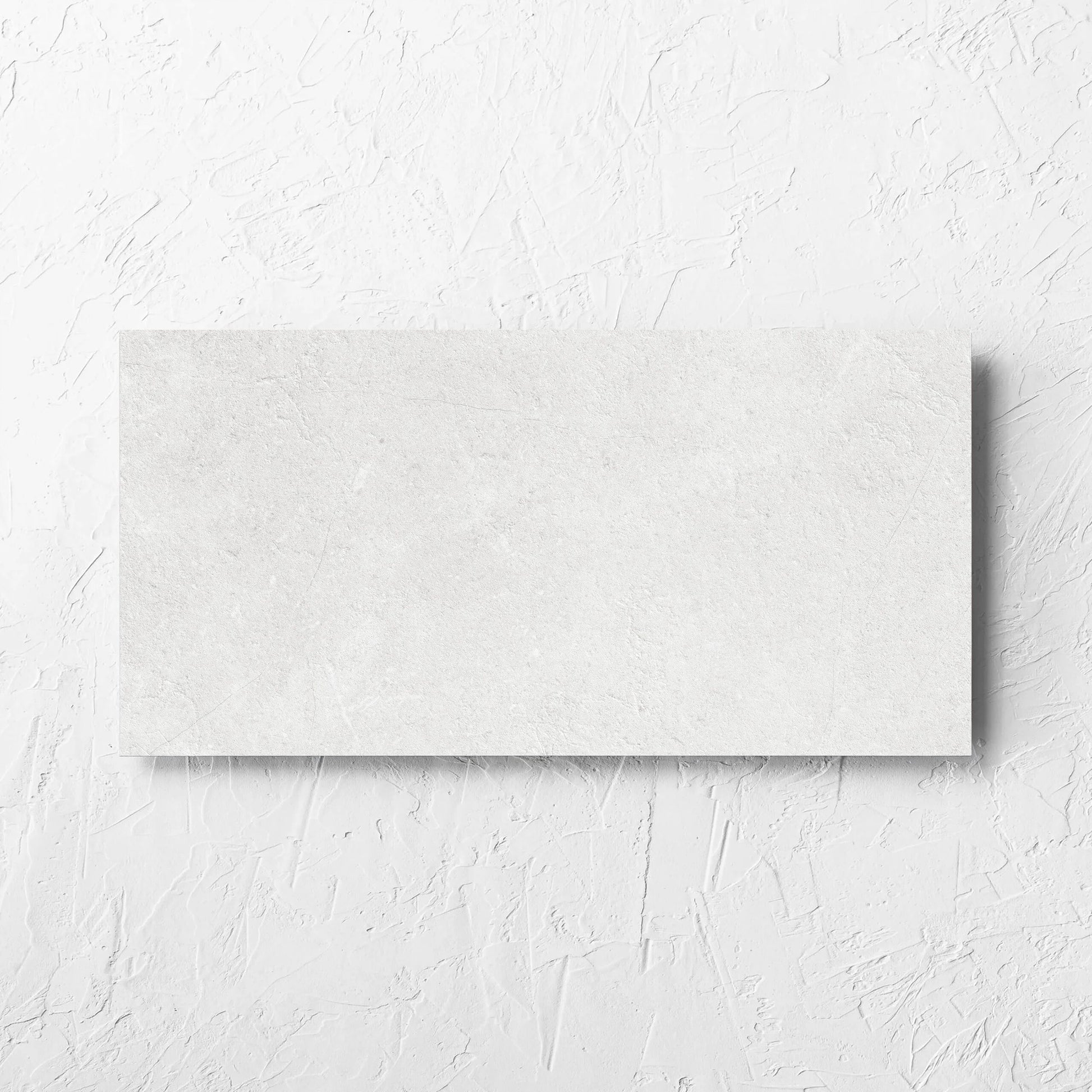 Lusso Bianco Matt 300x600mm tile laid flat on a white rendered wall, showing the matt surface