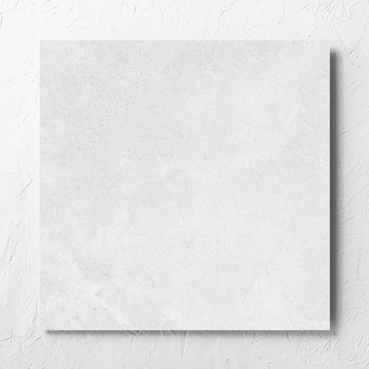 Lusso Bianco Matt 600x600mm tile laid flat on a white rendered wall, showing the matt surface