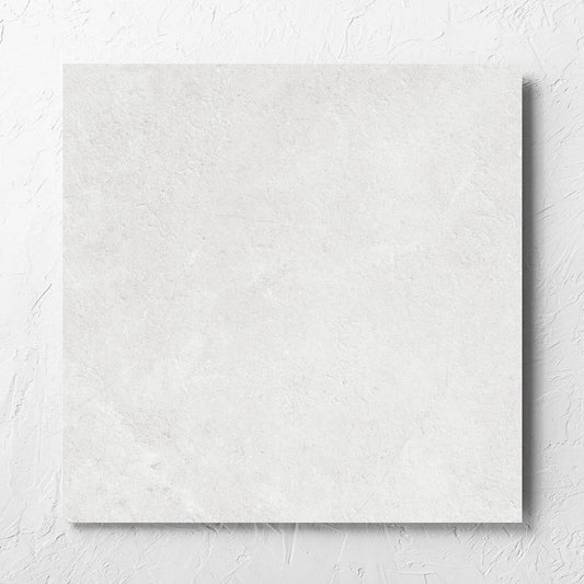 Lusso Bianco Matt 600x600mm tile laid flat on a white rendered wall, showing the matt surface