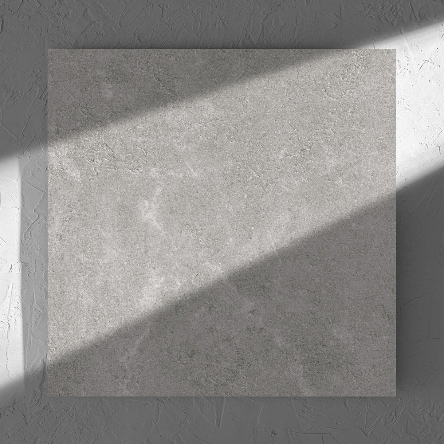 Lusso Grigio Amber 600x600mm tile in soft natural window light, showing the matt surface