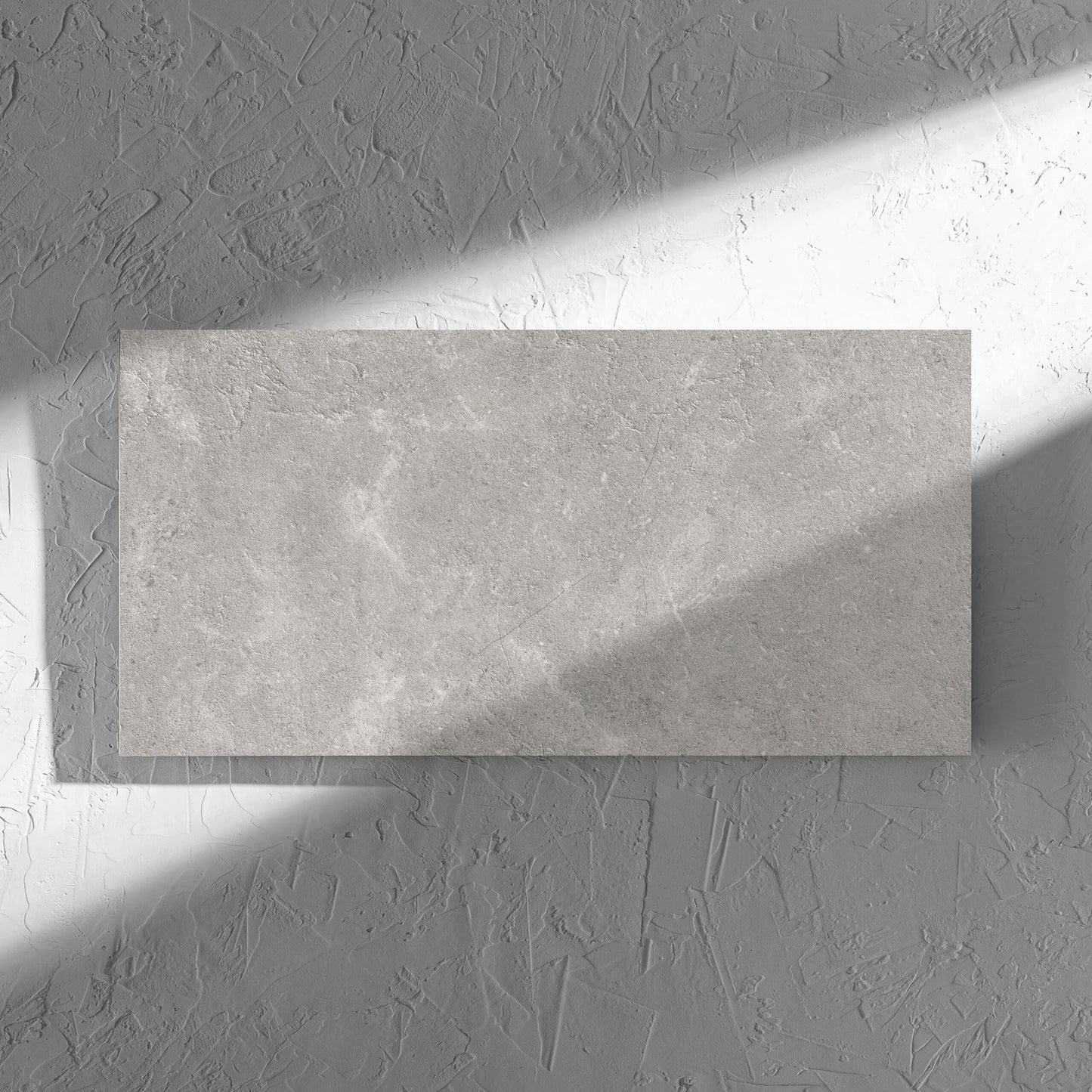 Lusso Grigio Matt 300x600mm tile in soft natural window light, showing the matt surface