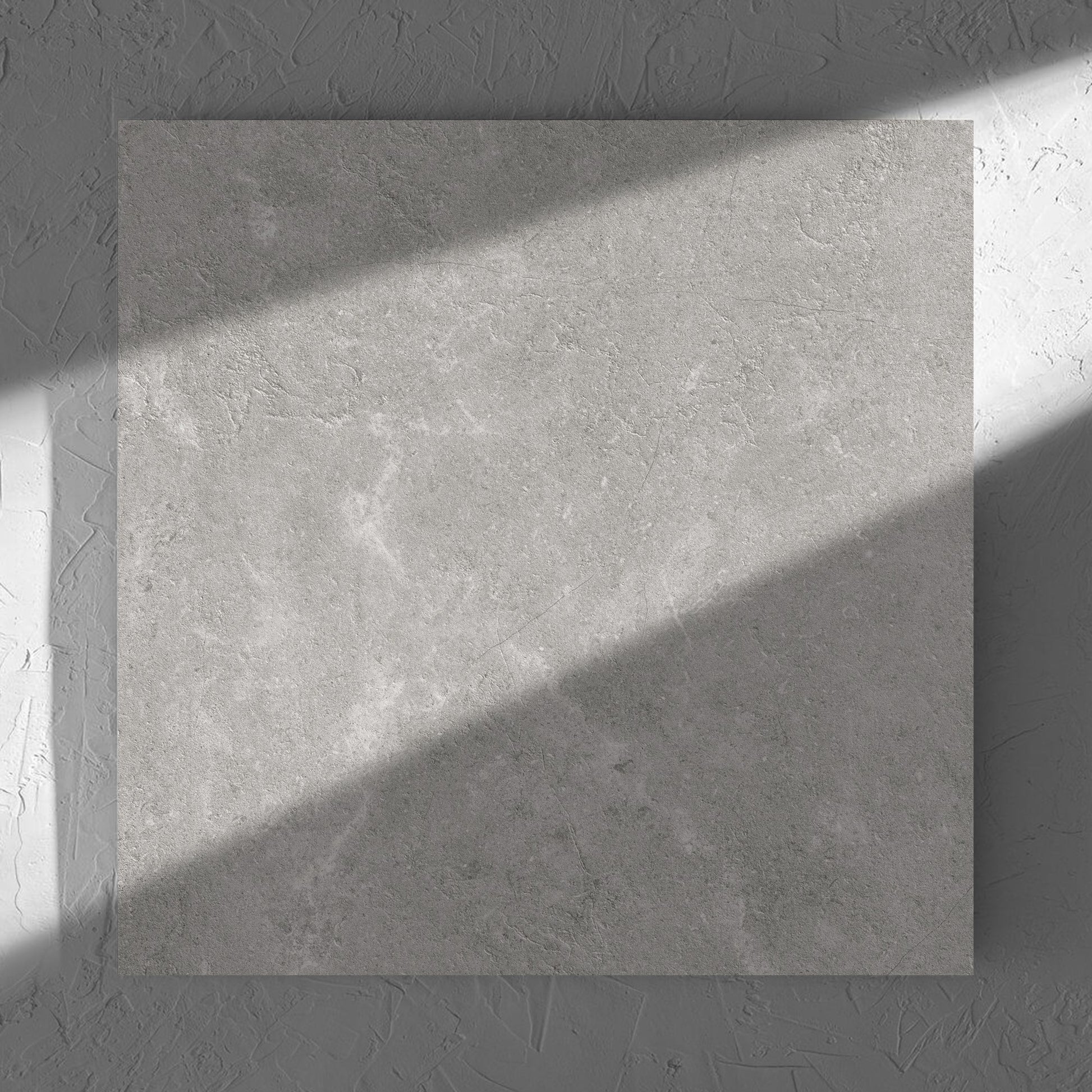 Lusso Grigio Matt 600x600mm tile in soft natural window light, showing the matt surface