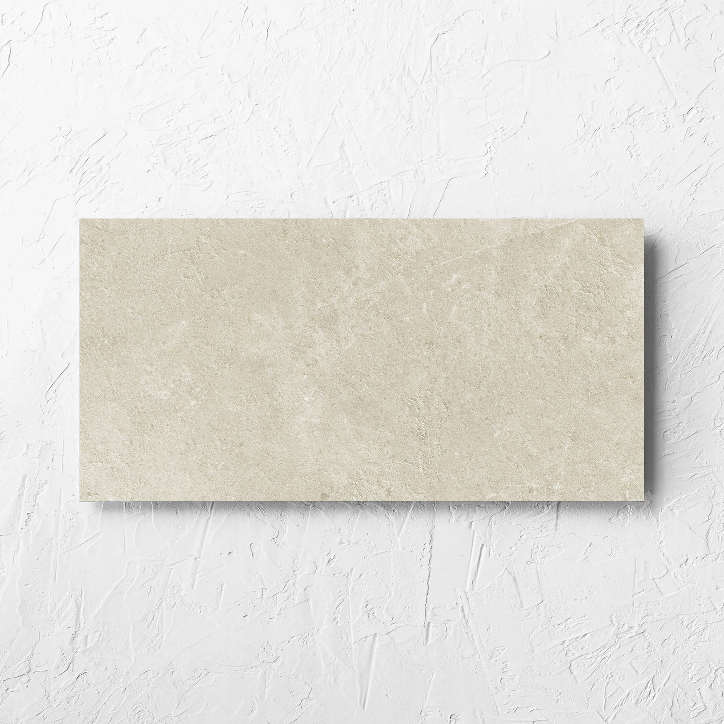 Lusso Naturale Matt 300x600mm tile laid flat on a white rendered wall, showing the matt surface