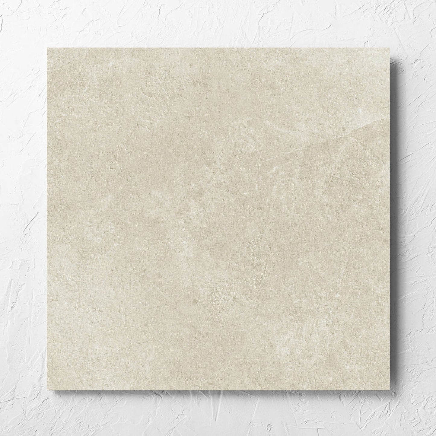 Lusso Naturale Matt 600x600mm tile laid flat on a white rendered wall, showing the matt surface