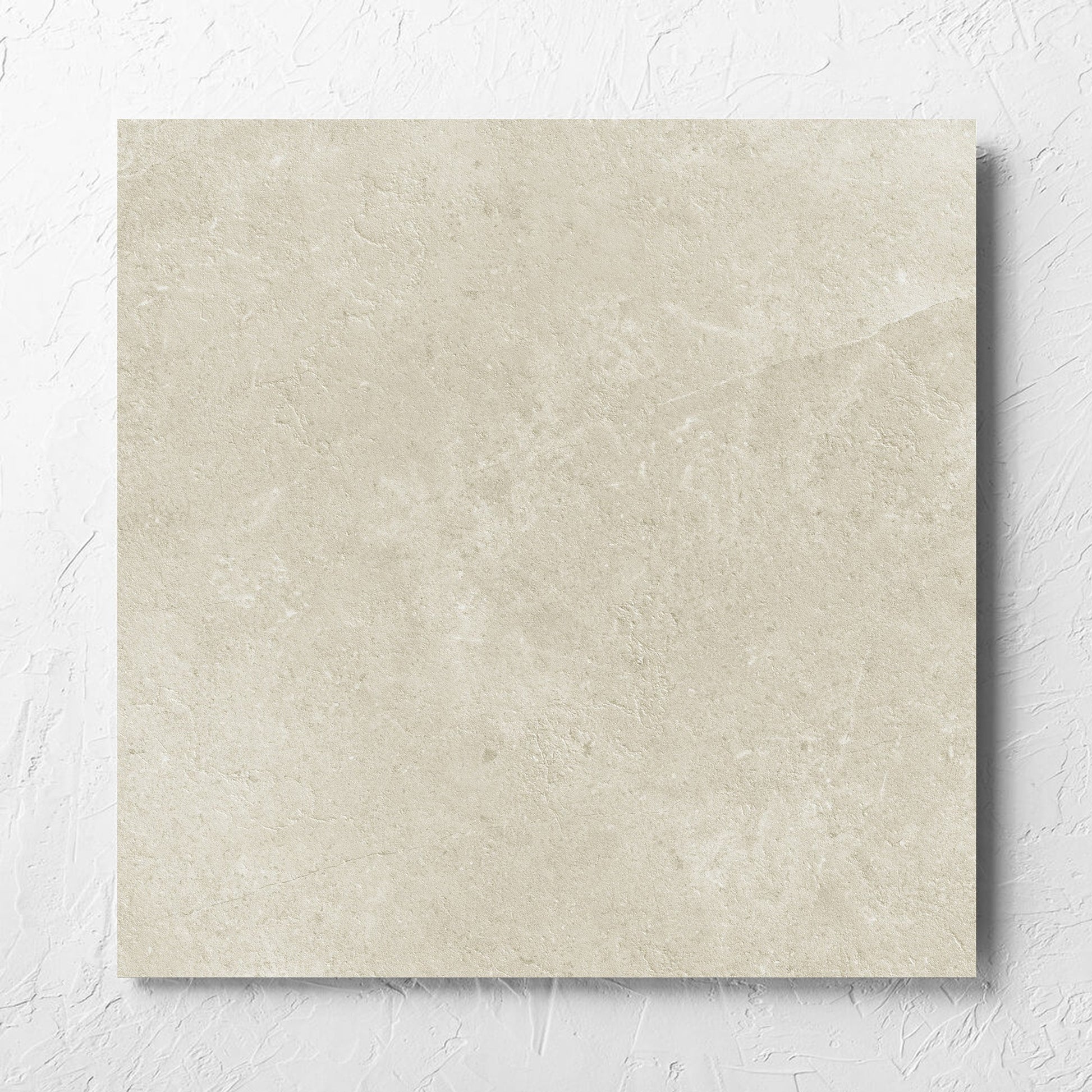 Lusso Naturale Matt 600x600mm tile laid flat on a white rendered wall, showing the matt surface