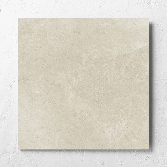 Lusso Naturale Matt 600x600mm tile laid flat on a white rendered wall, showing the matt surface