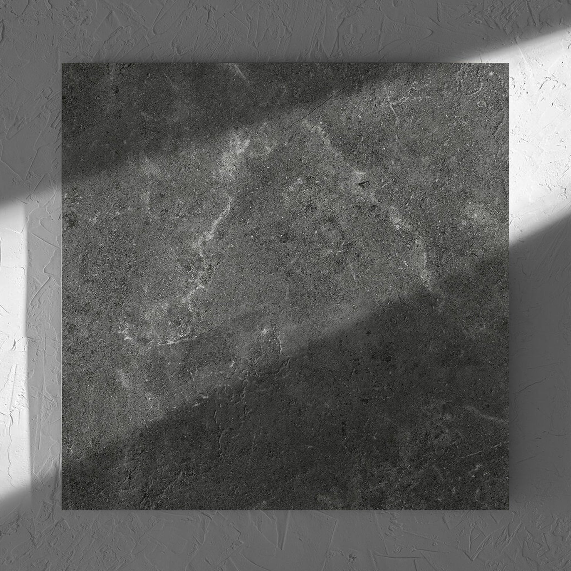 Lusso Nero Amber 600x600mm tile in soft natural window light, showing the matt surface