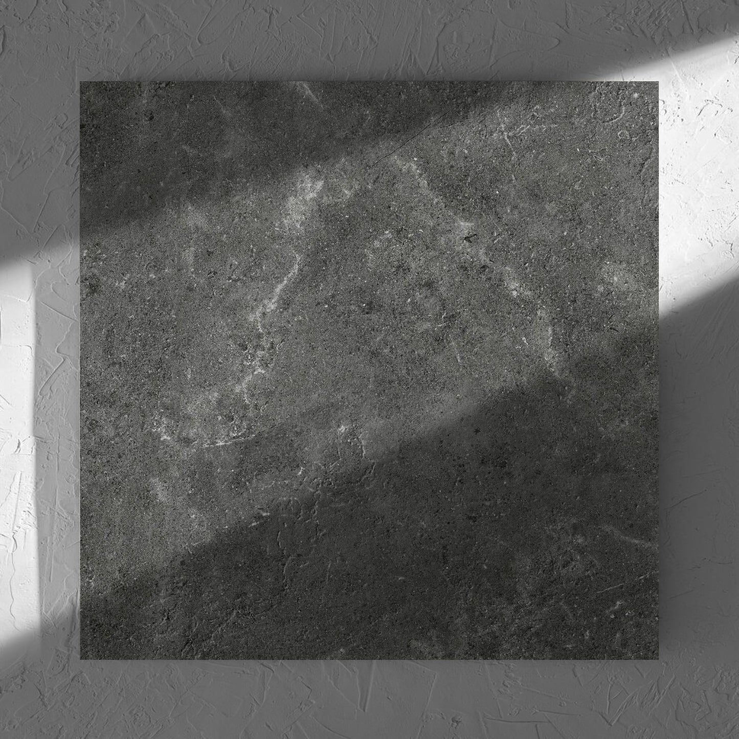 Lusso Nero Matt 600x600mm tile in soft natural window light, showing the matt surface
