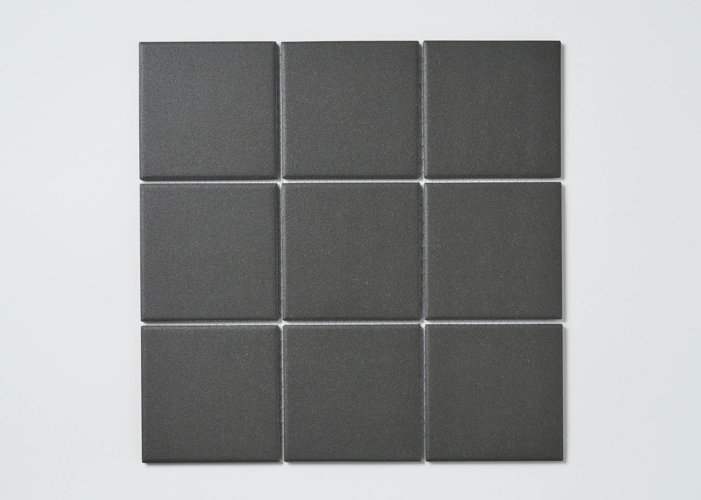 Nine Marlowe Black Matt Mosaic 97x97mm tiles arranged in a 3x3 grid, showcasing their matte charcoal finish and square format.