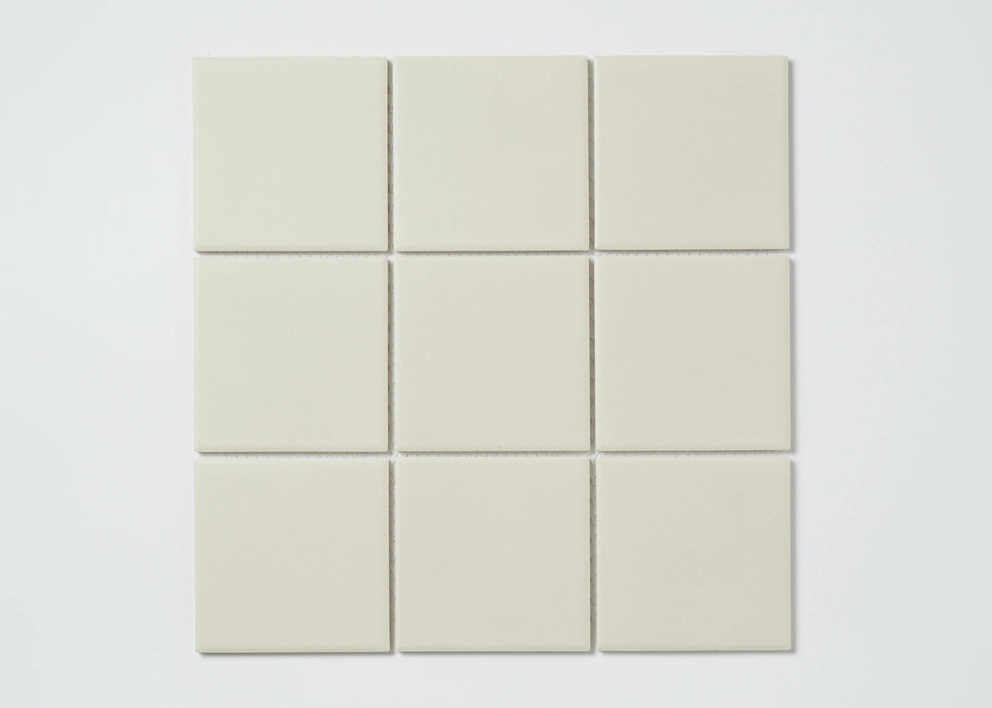 Marlowe Bone Matt Mosaic 97x97mm tiles arranged in a 3x3 grid, showing uniform matt finish and soft off-white colour.
