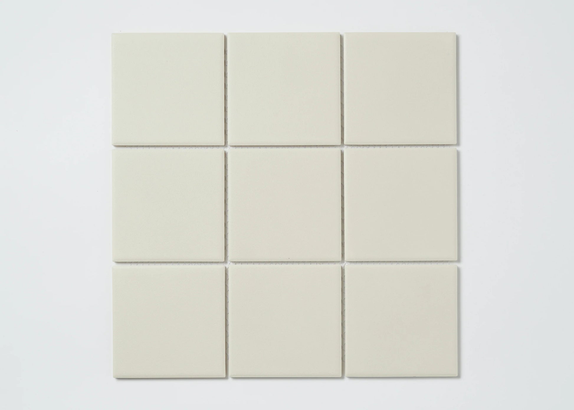 Marlowe Bone Matt Mosaic 97x97mm tiles arranged in a 3x3 grid, showing uniform matt finish and soft off-white colour.