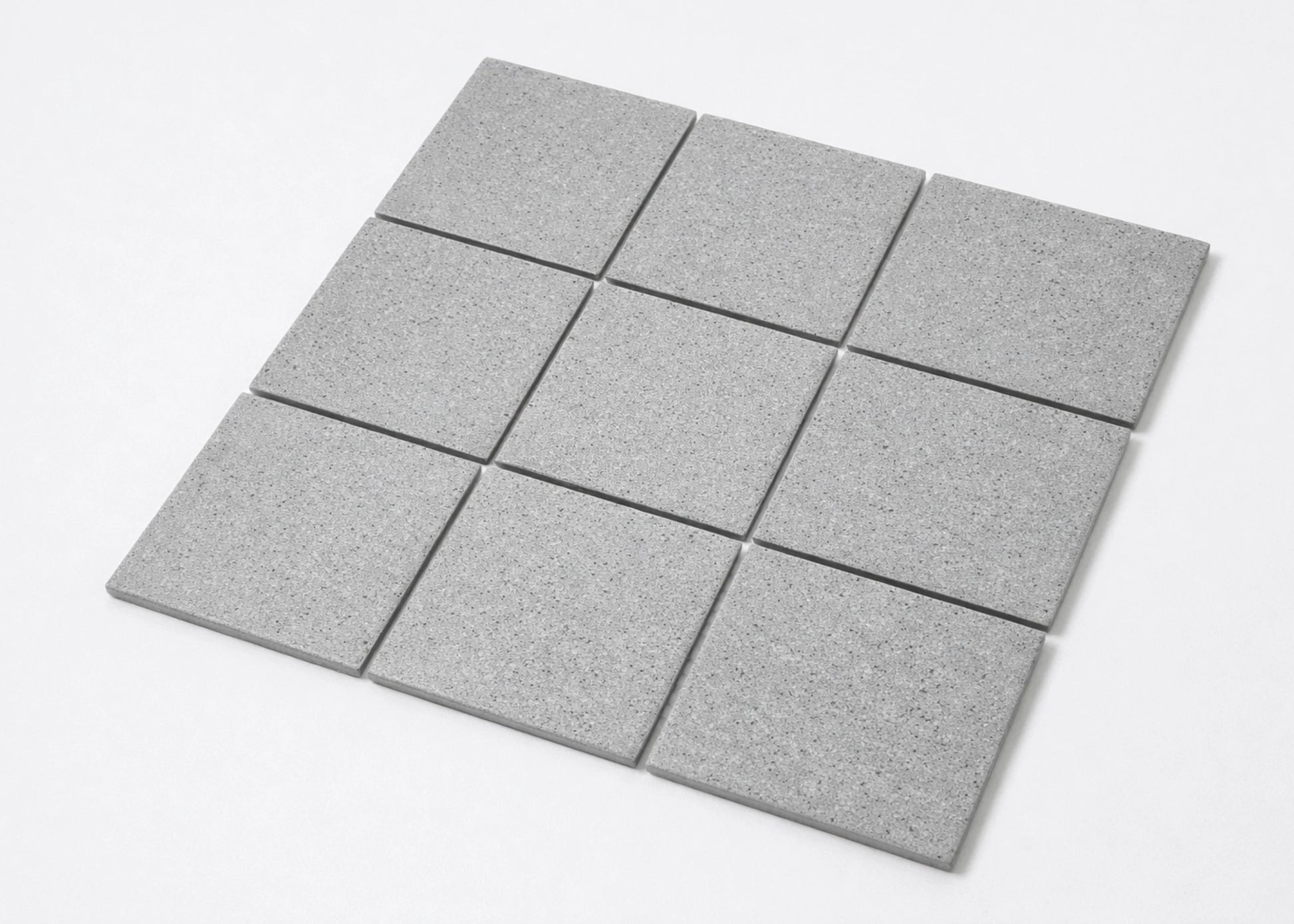 Pack shot of Marlowe Cement Speckled Matt Mosaic 97x97mm tiles arranged in a 3x3 grid showing their grey speckled matt finish and square shape.