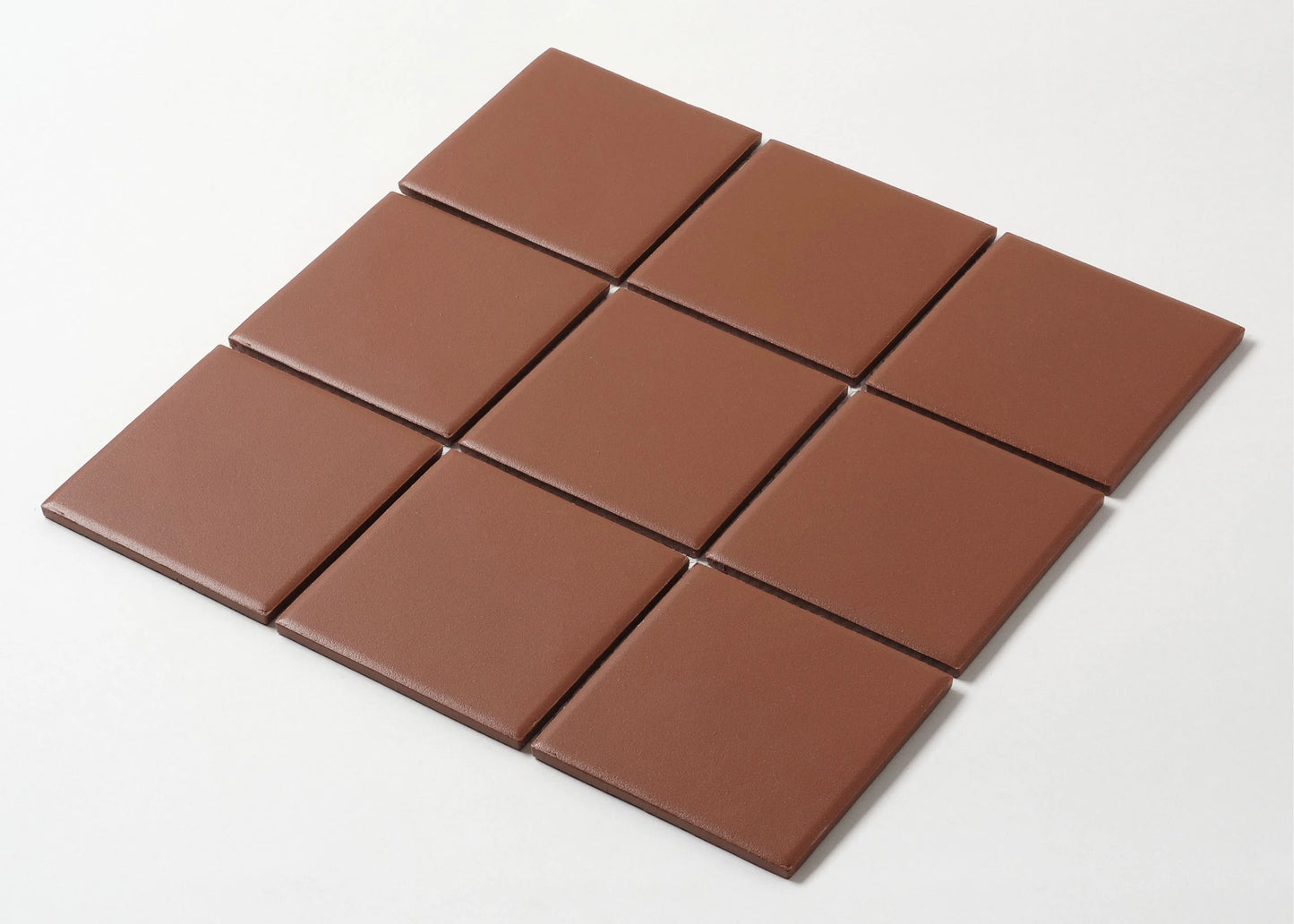 Pack shot of Marlowe Chestnut Red Matt Mosaic 97x97mm tiles arranged in a 3x4 grid, showing smooth matte finish and warm terracotta-brown colour.