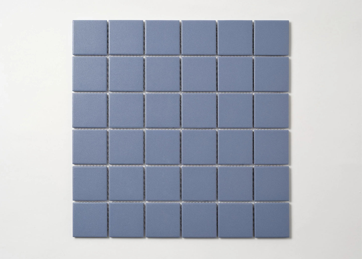 Pack shot of Marlowe Cornflower Blue Matt Mosaic 48×48 mm showing a flat grid of square matte blue-grey ceramic tiles with uniform grout joints.