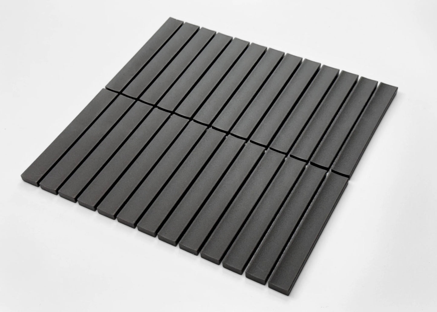 Pack shot of Marlowe Onyx Concave Speckled Matt Rectangle 20x145mm tiles arranged in a flat-lay grid, showcasing their dark charcoal matte finish and slim linear shape.