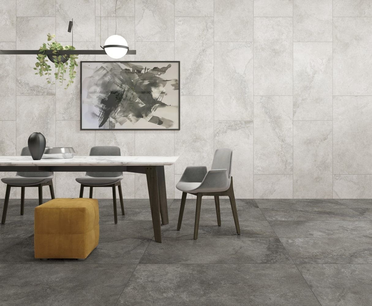 Mars Light External Pencil Bullnose 390.80x600x20mm installed as a light grey marble-look feature wall in a modern dining room with dark floor tiles, pendant light, and abstract artwork.