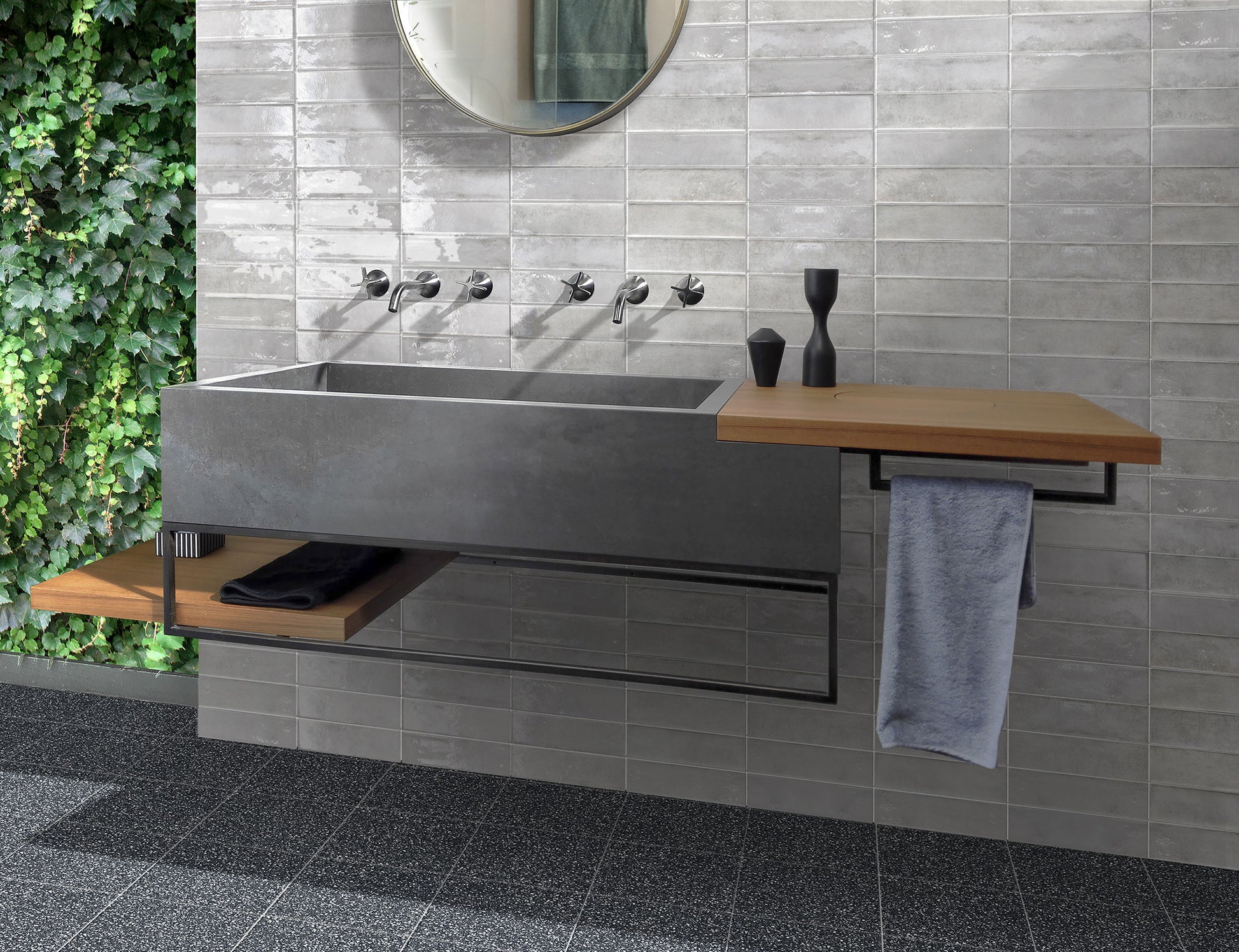 Memory Pearl Grey Gloss 60x250mm tiles installed as a bathroom feature wall behind a concrete double basin vanity with timber shelf and round mirror.