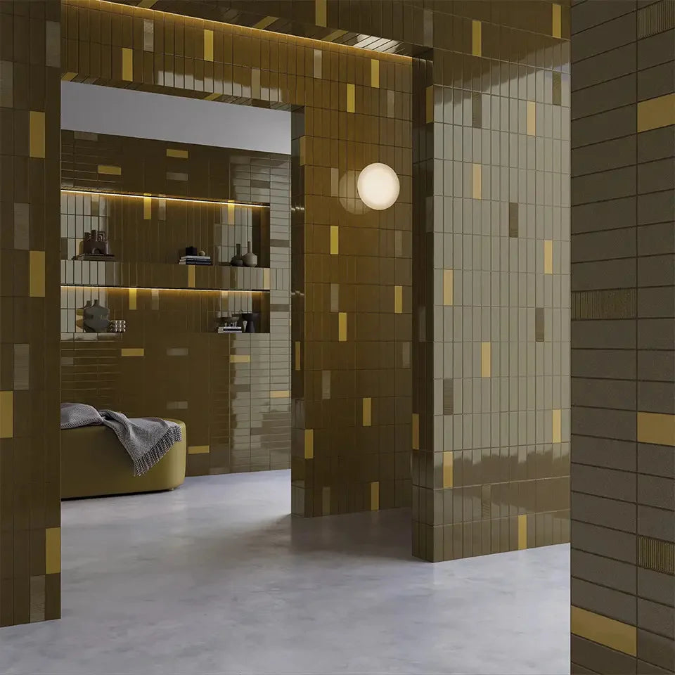 Micare Ambar Dark Gloss 50x150mm tiles covering walls and archways in an olive-gold interior space featuring built-in shelving and a spherical wall light.