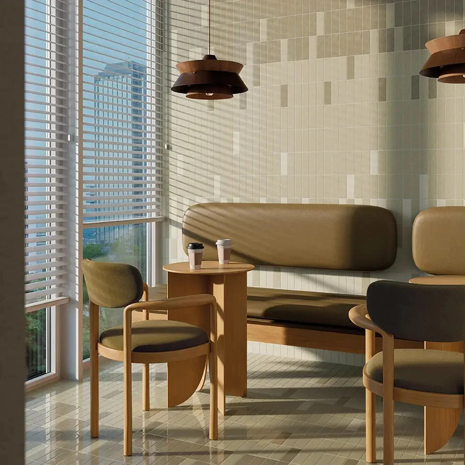 Micare Linen Dark Gloss 50x150mm tiles in a warm cafe seating area featuring a leather banquette, wooden chairs, and pendant lighting.