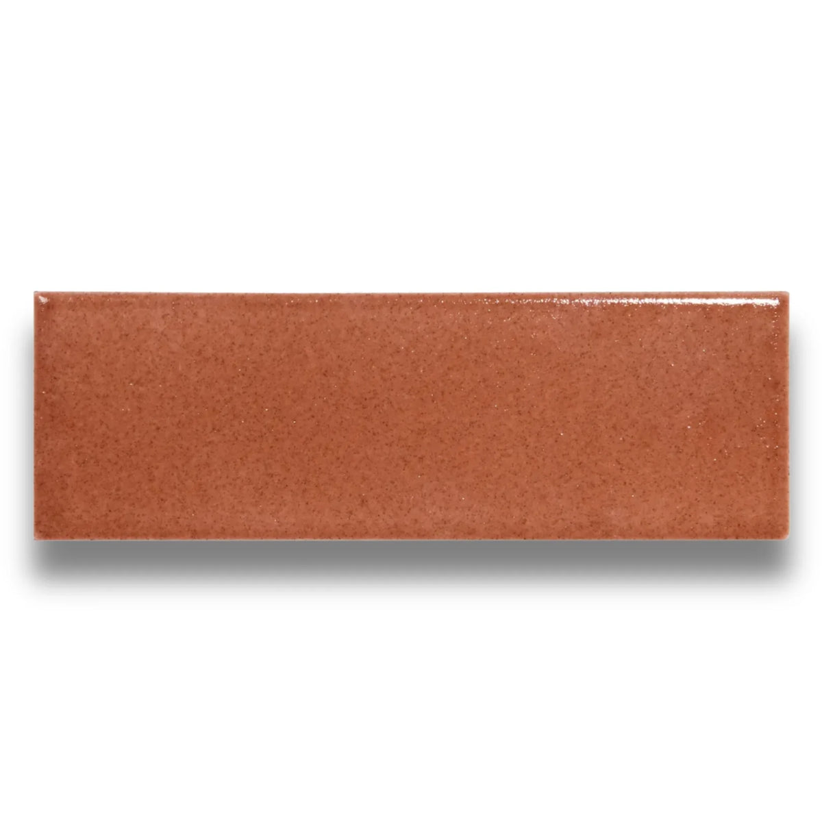 Single glazed ceramic brick tile, Micare Saffron Light Gloss 50x150mm, shown in a warm terracotta-orange tone with a smooth high-gloss finish and subtle speckled texture.