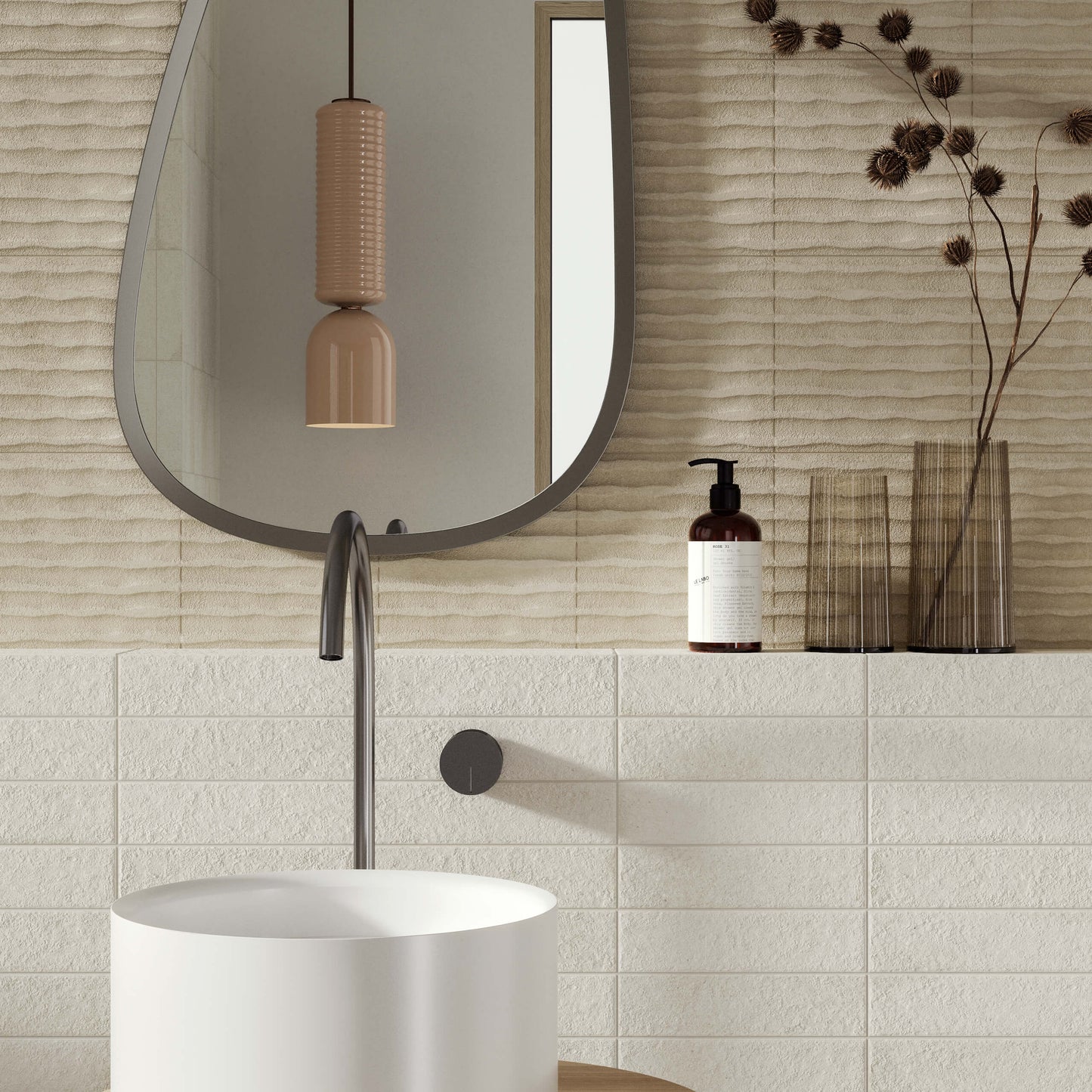 Miniature Fornace Bianco Minerale 60x240mm tiles installed in a modern bathroom featuring a round pedestal basin, arched mirror, and ceramic pendant light.