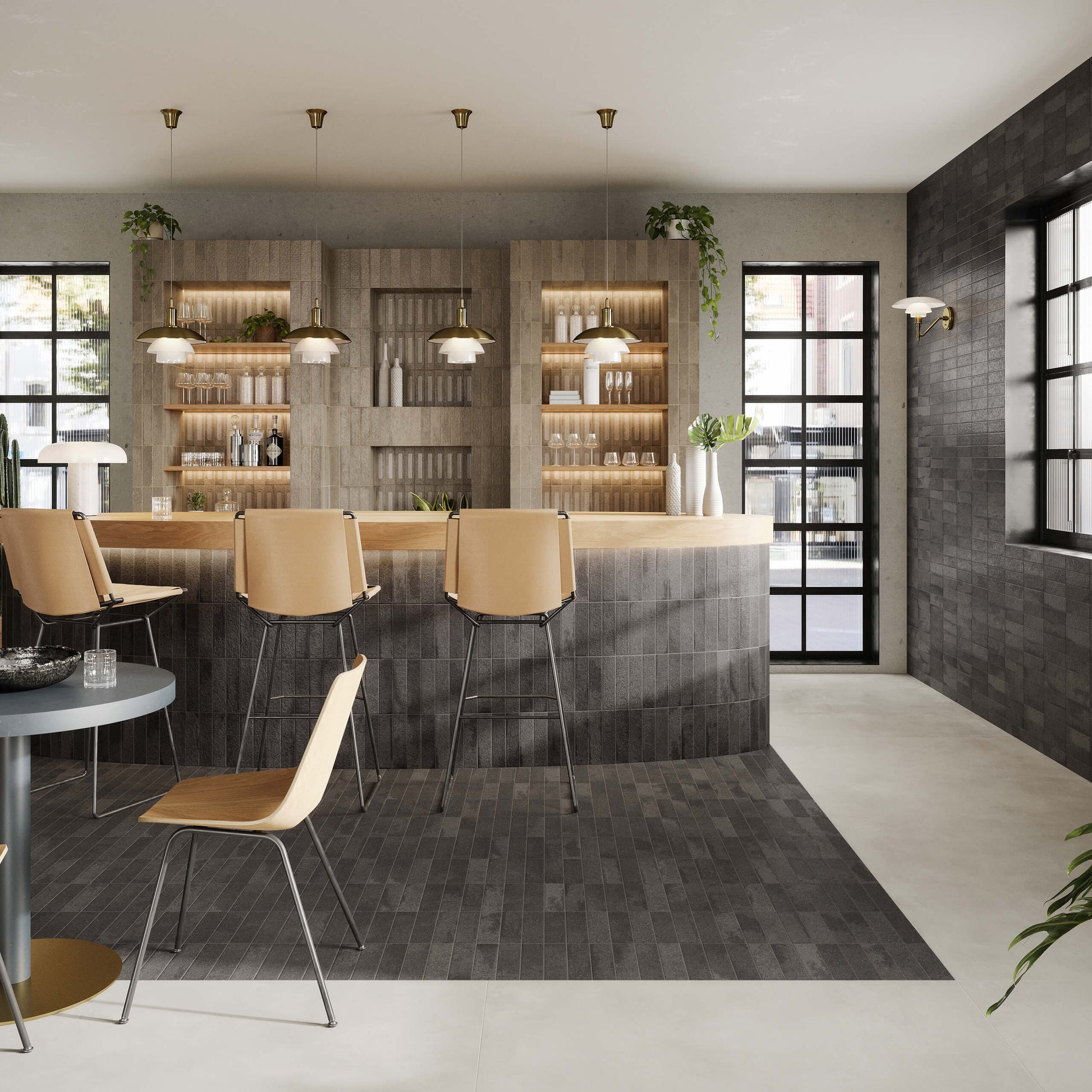 Miniature Fornace Nero Fumo 60x240mm dark charcoal tiles installed on a modern bar counter, floor, and feature wall with warm pendant lights and timber barstools.