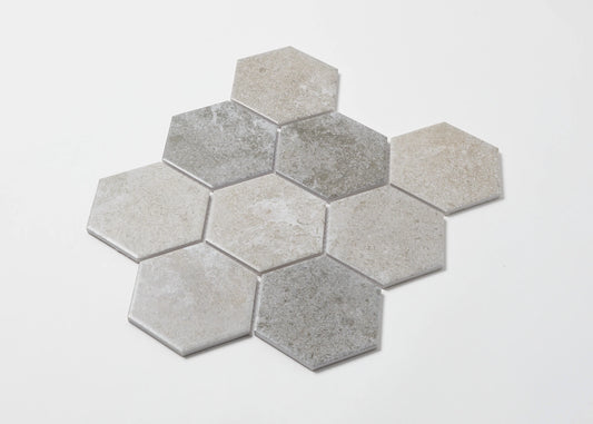 Pack shot of Mixed Colours Matte Porcelain Glazed Hexagon 95x110mm tiles arranged in a honeycomb cluster, showing varied grey and beige matte stone-look finishes.