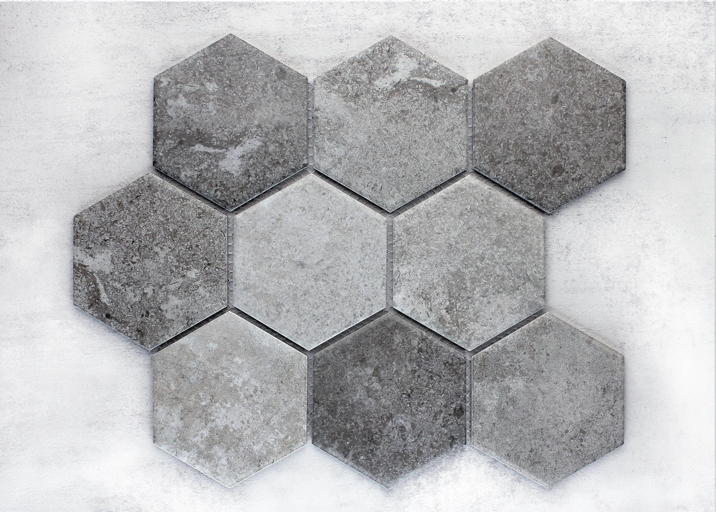 Mixed Colours Matte Porcelain Glazed Hexagon 95x110mm tiles arranged in a honeycomb cluster displaying varied grey stone-effect matte finishes.