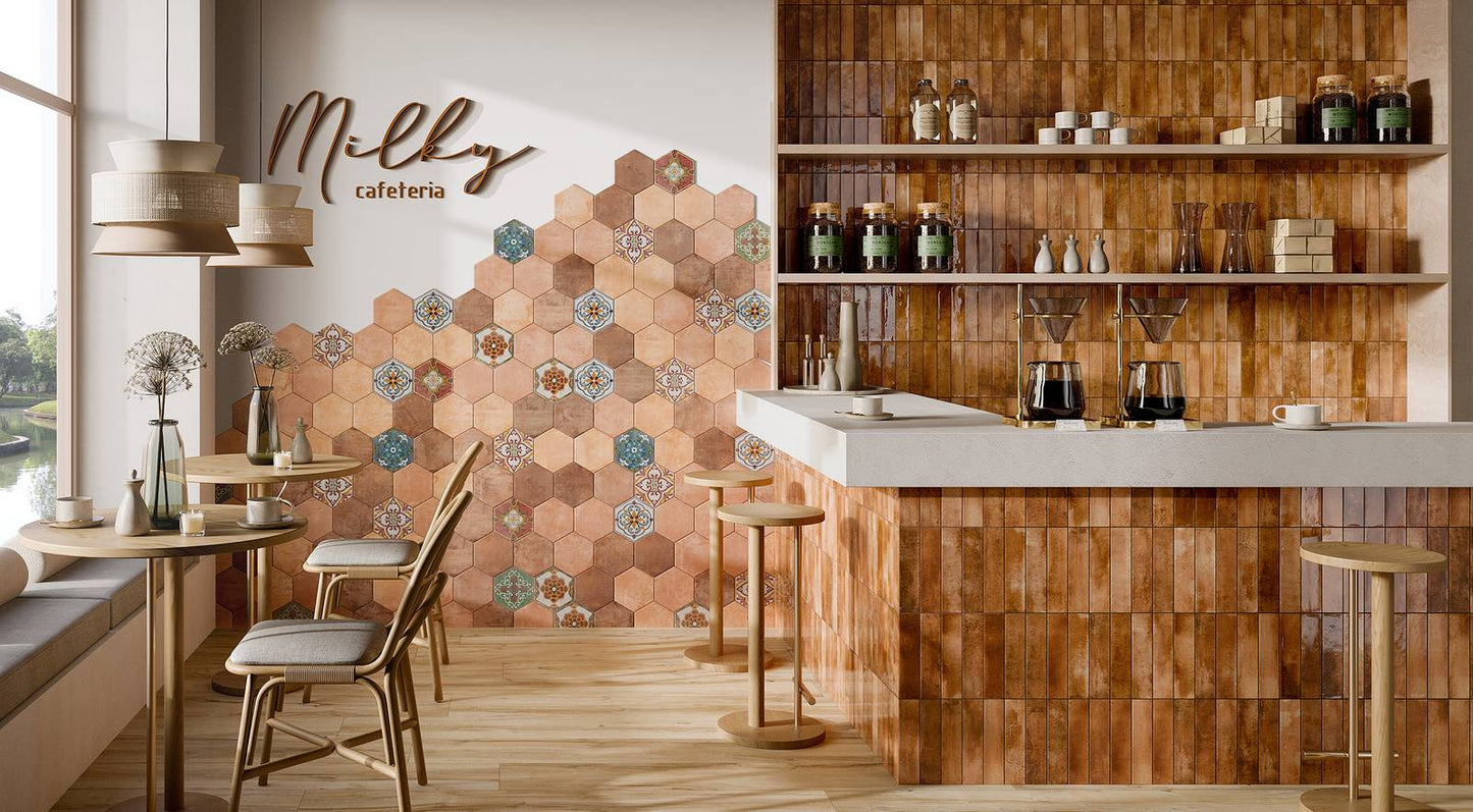 Mojave Cotto Brick 60x250mm tiles covering a warm terracotta bar counter and shelving in a stylish café interior with pendant lights and hexagonal feature wall.