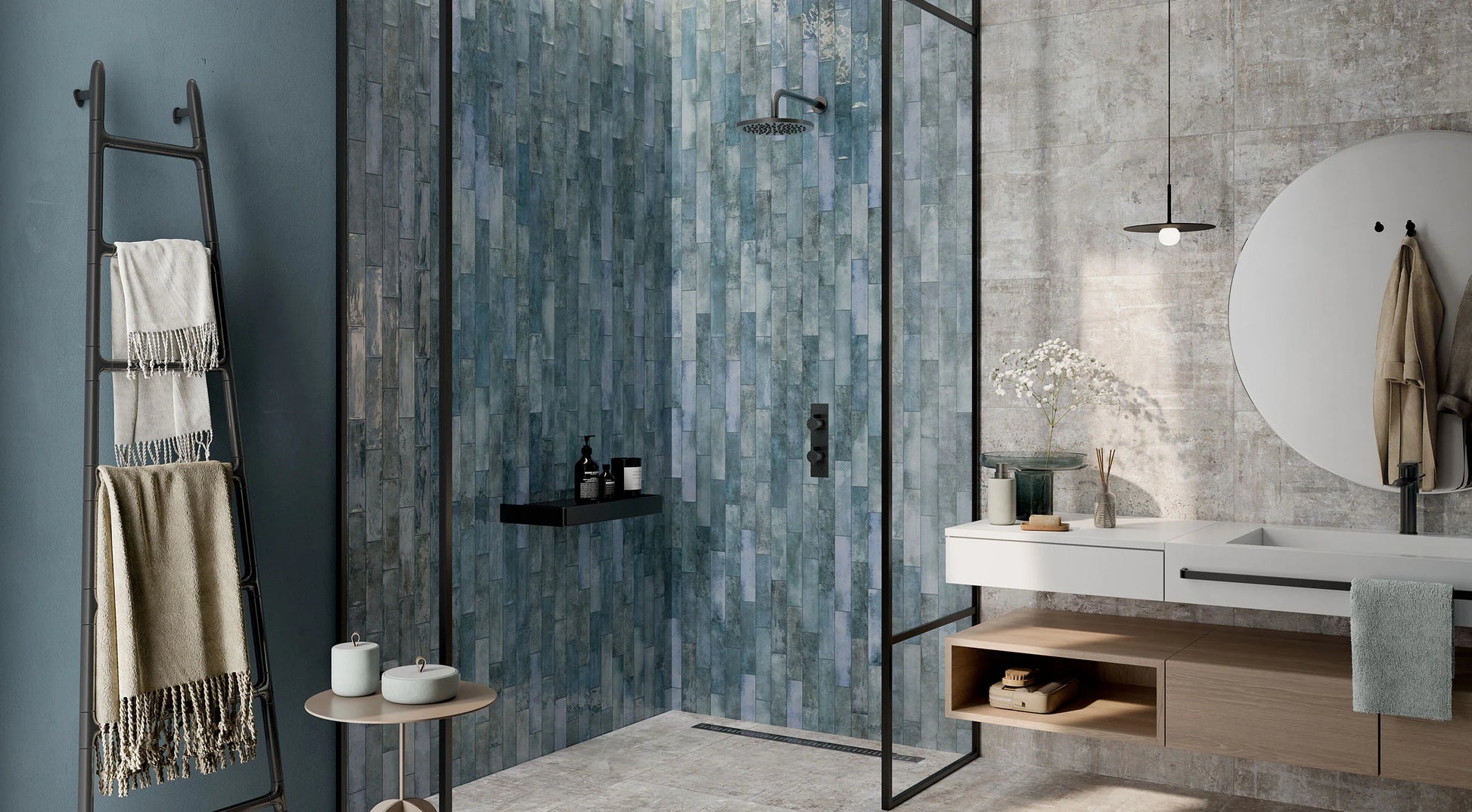 Mojave Denim Brick 60x250mm tiles covering a walk-in shower feature wall in blue-grey tones, paired with a floating white vanity and black fixtures.
