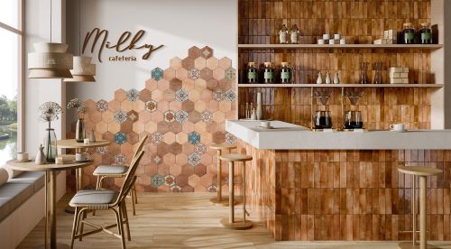 Mojave Ocra Brick 60x250mm warm terracotta tiles covering a cafe bar counter and shelving unit, complemented by decorative hexagonal wall tiles and wooden furniture.
