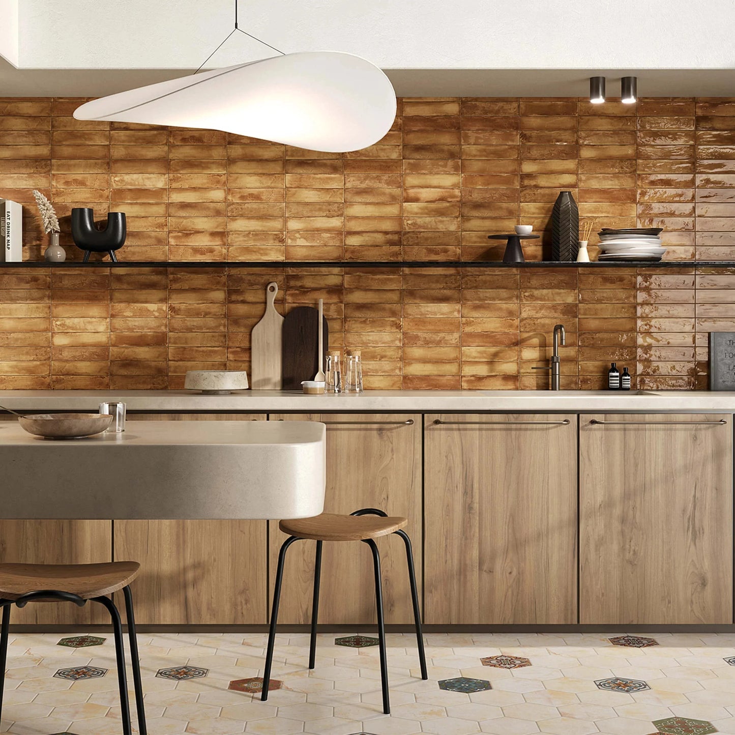 Mojave Ocra Brick 60x250mm warm amber glazed tiles covering a full-height kitchen splashback wall with wood cabinets and pendant light.